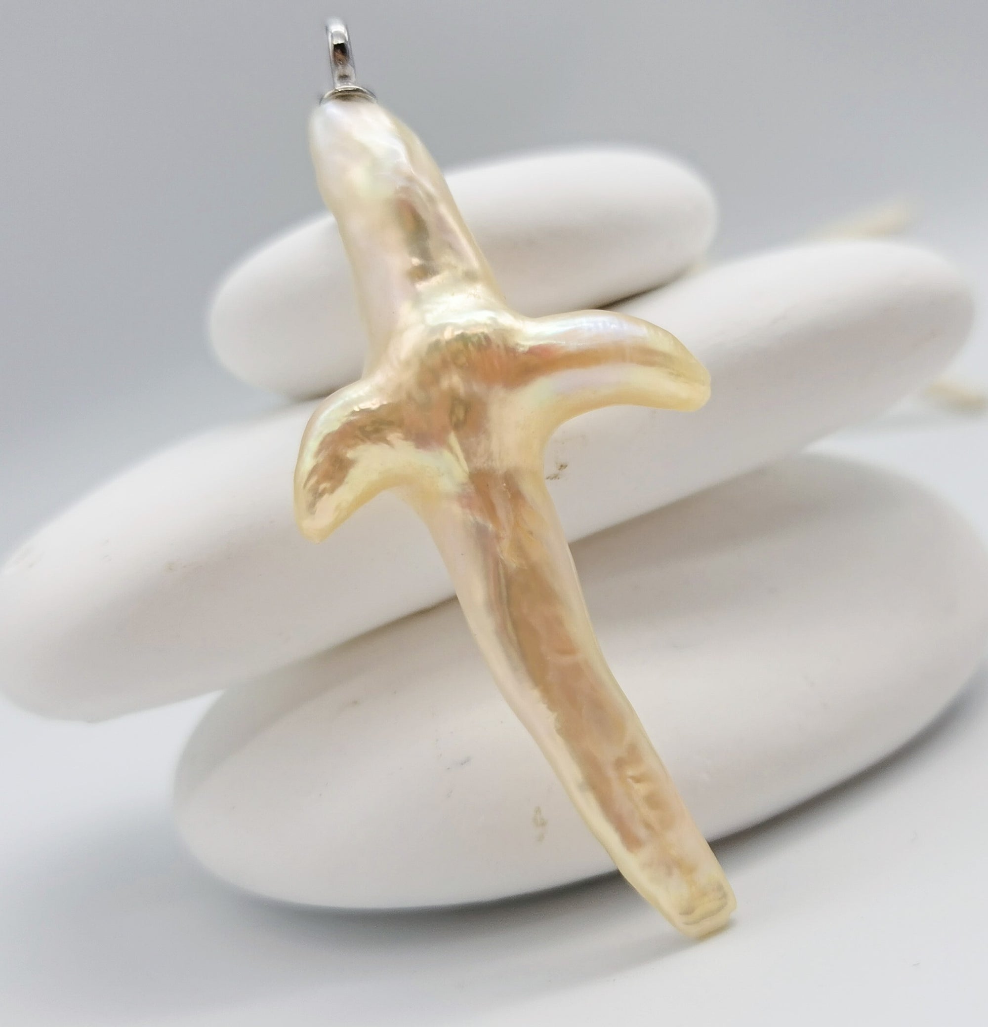 Cross-shaped baroque pearl pendant 6.5x3cm nucleus-free freshwater pearl creamy lustre golden undertones sterling silver bail