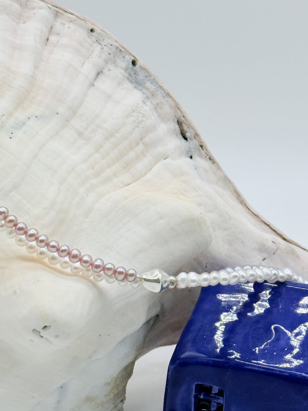 Close up details of the silver beads on the seed pearl strand of the freshwater twin strand necklace. 
