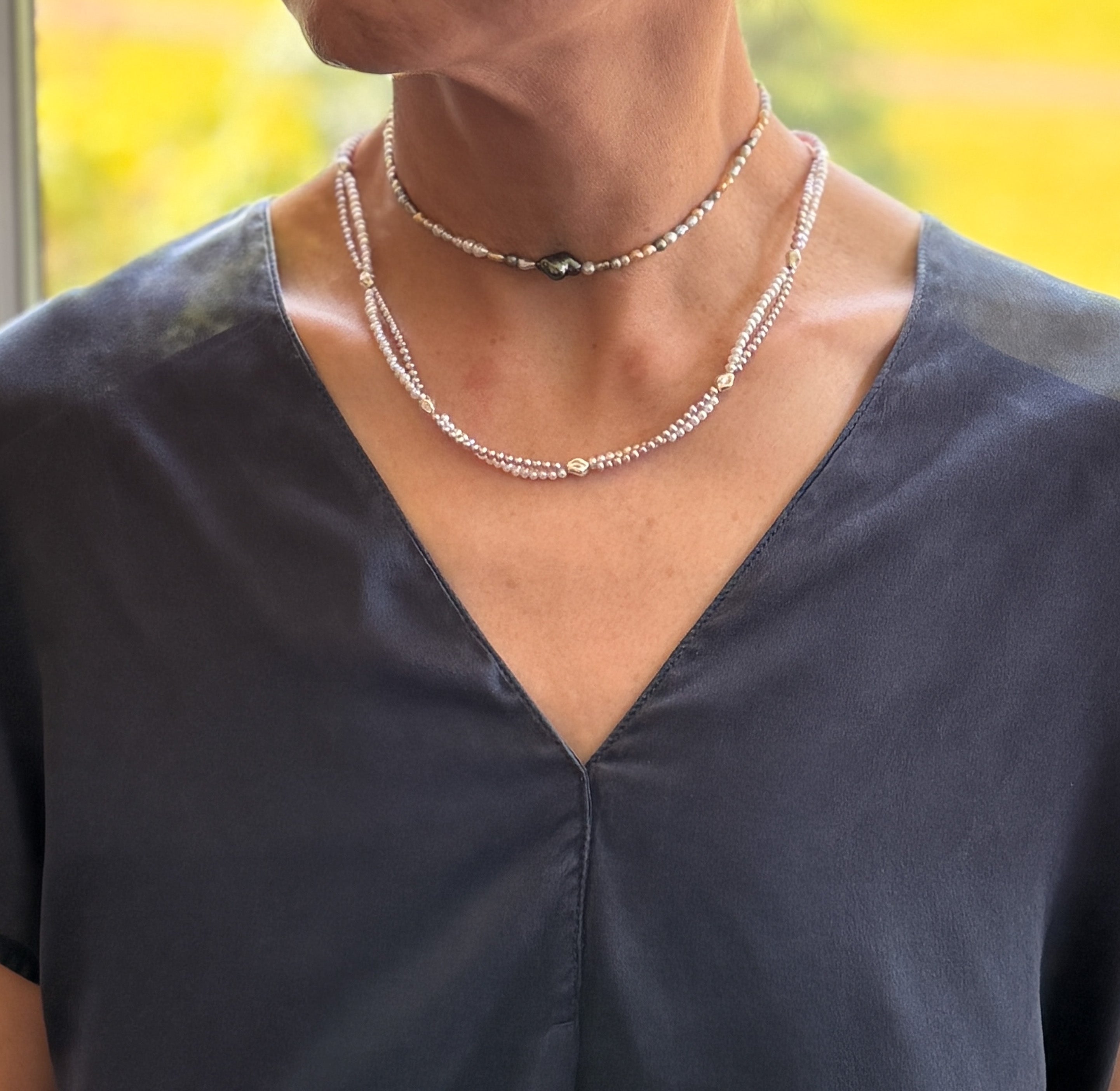 Model wearing FRESHWATER WHITE PURPLE TWIN STRAND with warm background 