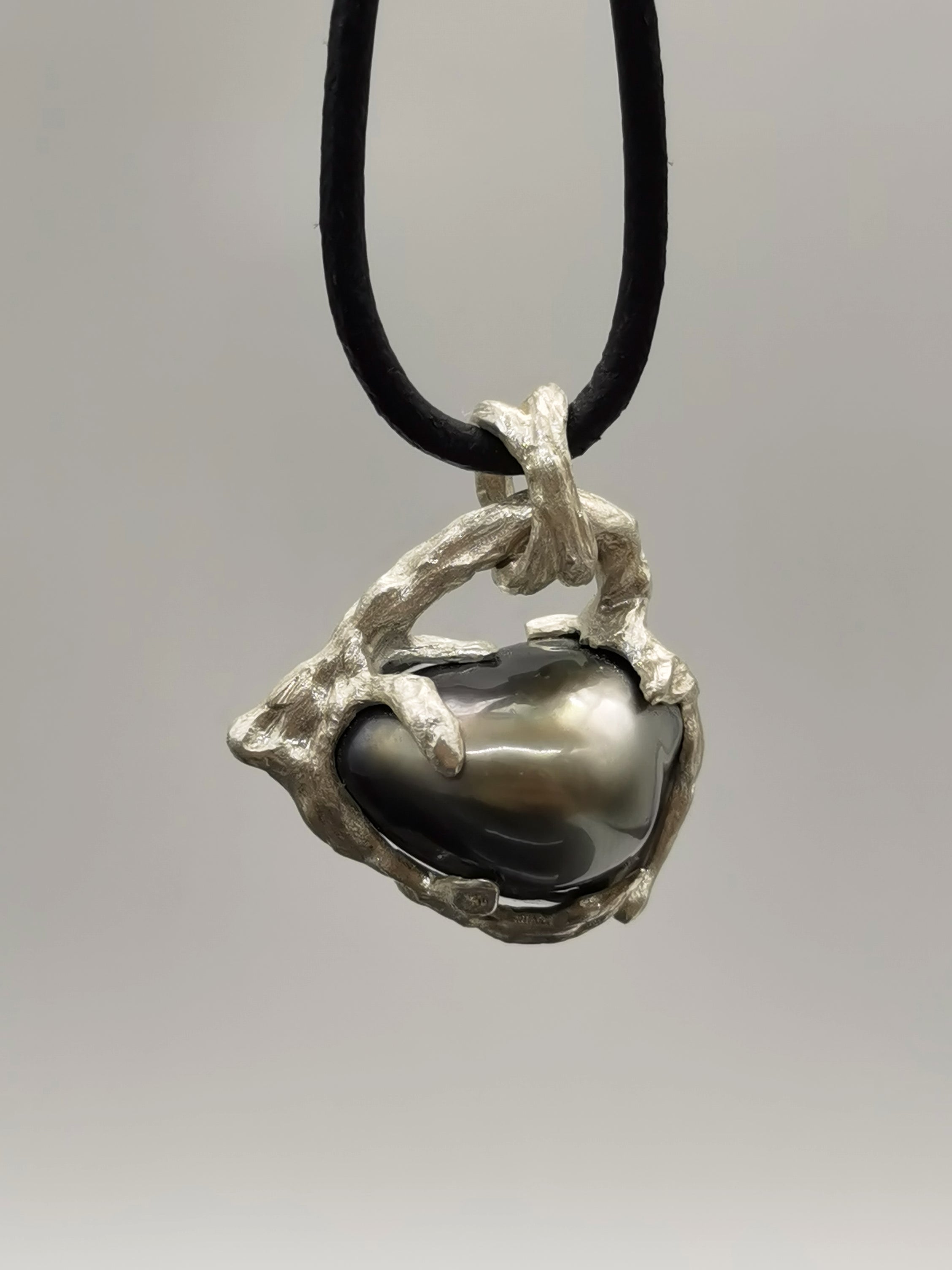 TAHITIAN PEARL HEART PENDANT attached to a black cord to show of the modern and unique style of the jewellery