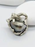 Details of the Tahitian pearl heart pendant's intricate silver work and high lustre of the pearl giving out high reflection