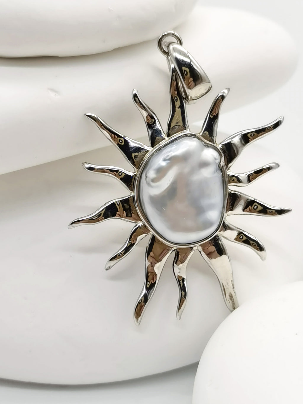 CLOSE UP VIEW OF BAROQUE SUNBURST PENDANT ALONE against white background 