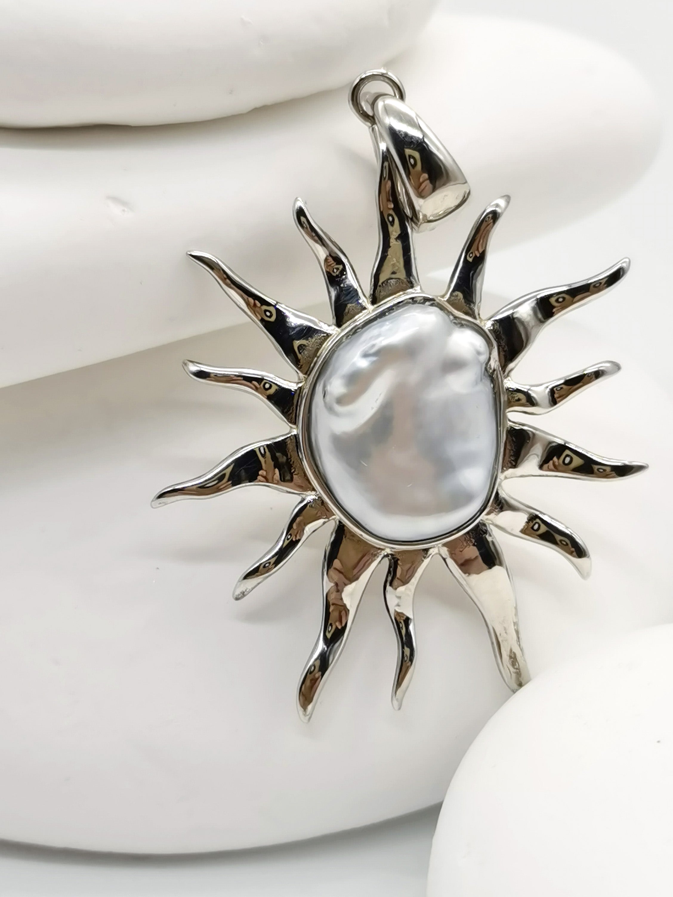 CLOSE UP VIEW OF BAROQUE SUNBURST PENDANT ALONE against white background 