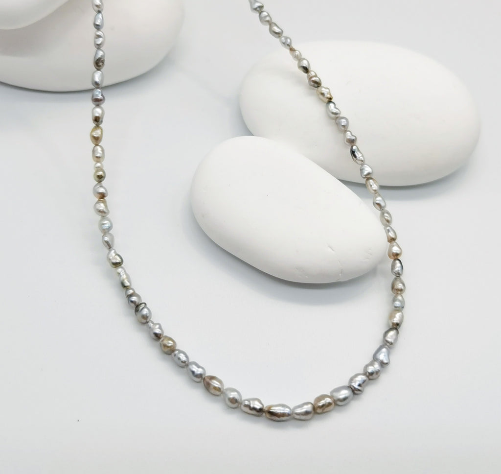 CLOSE UP VIEW OF PAIRNING NECKLACE OPTION FOR BAROQUE SUNBURST PENDANT, lay flat on white back ground