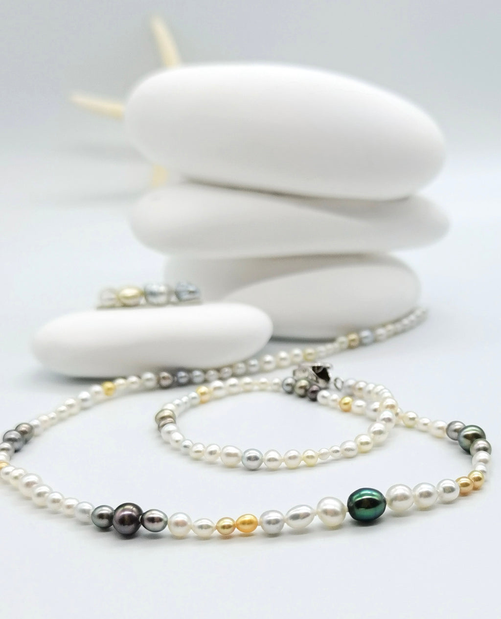 Close up of gold and white south sea keshi pearl necklace with fancy colour Tathitian keshi pearls