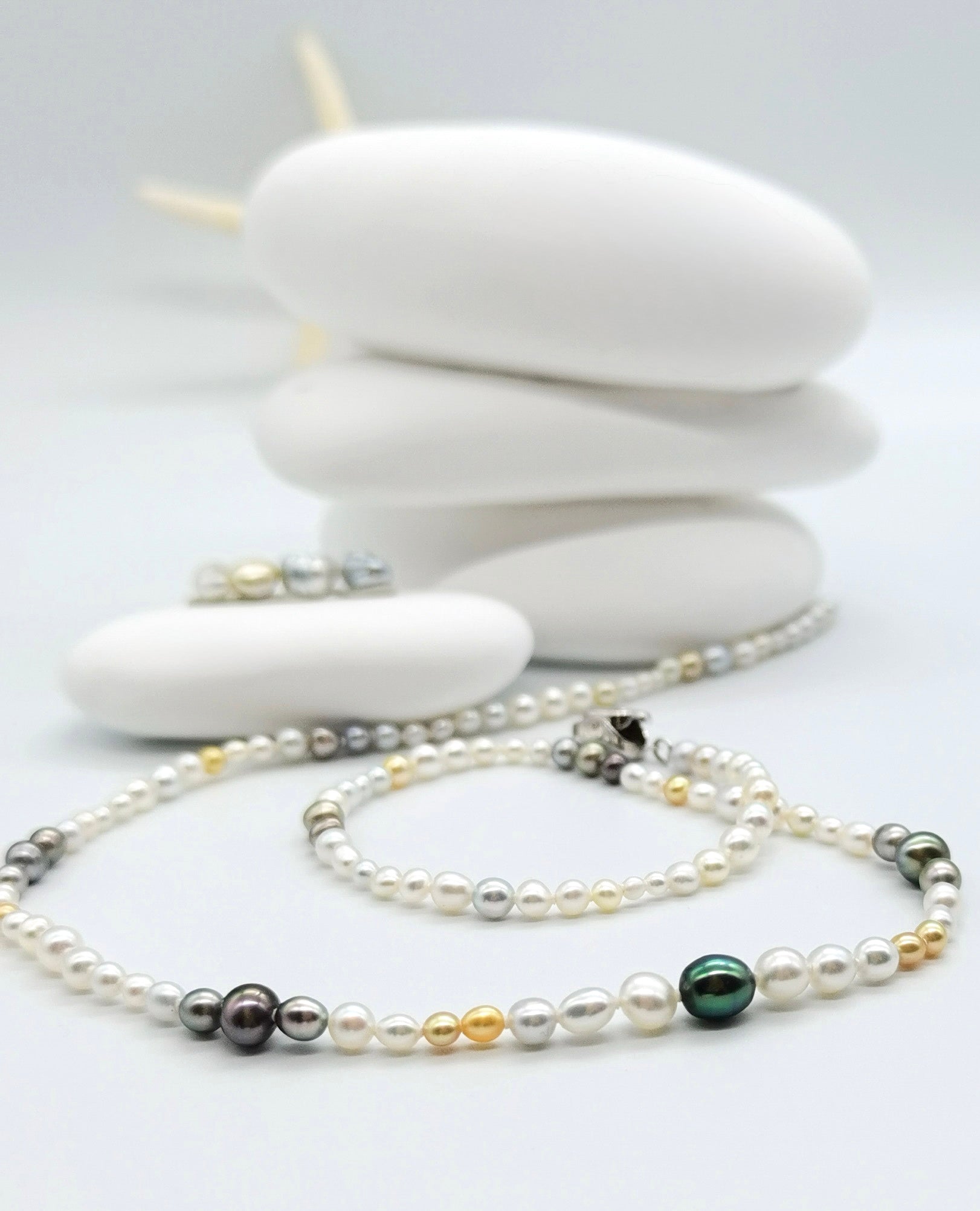 Close up of gold and white south sea keshi pearl necklace with fancy colour Tathitian keshi pearls