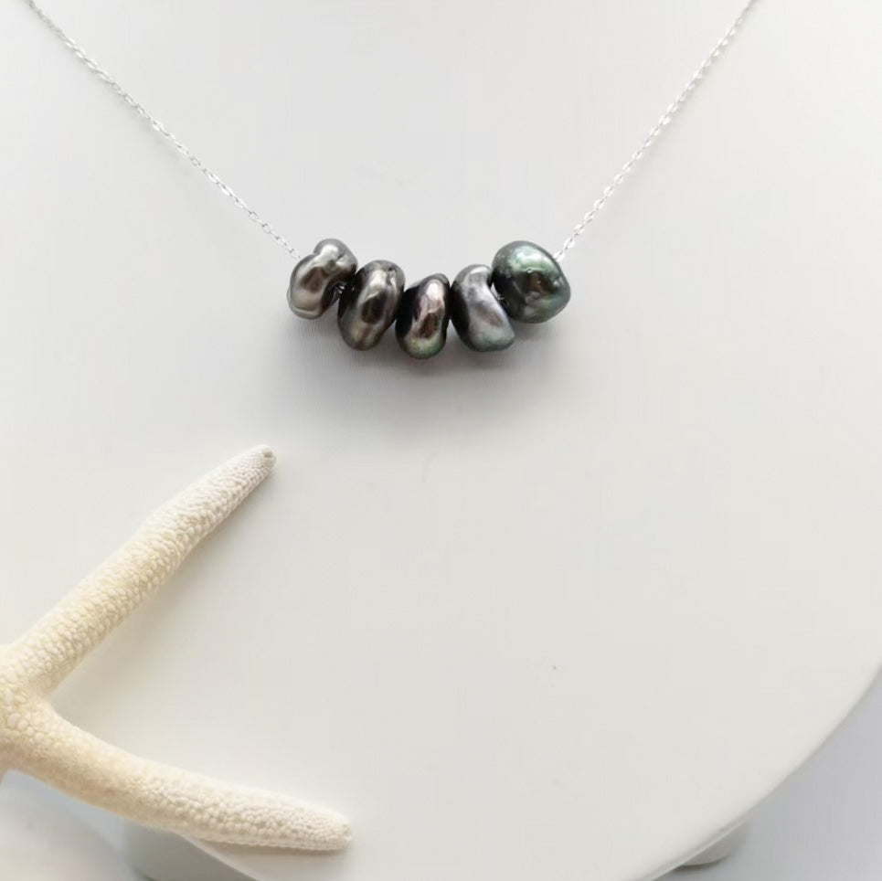 Large Tahitian Keshi 5-pearl floating necklace detail showing baroque pearls bronze green violet iridescence 925 sterling silver
