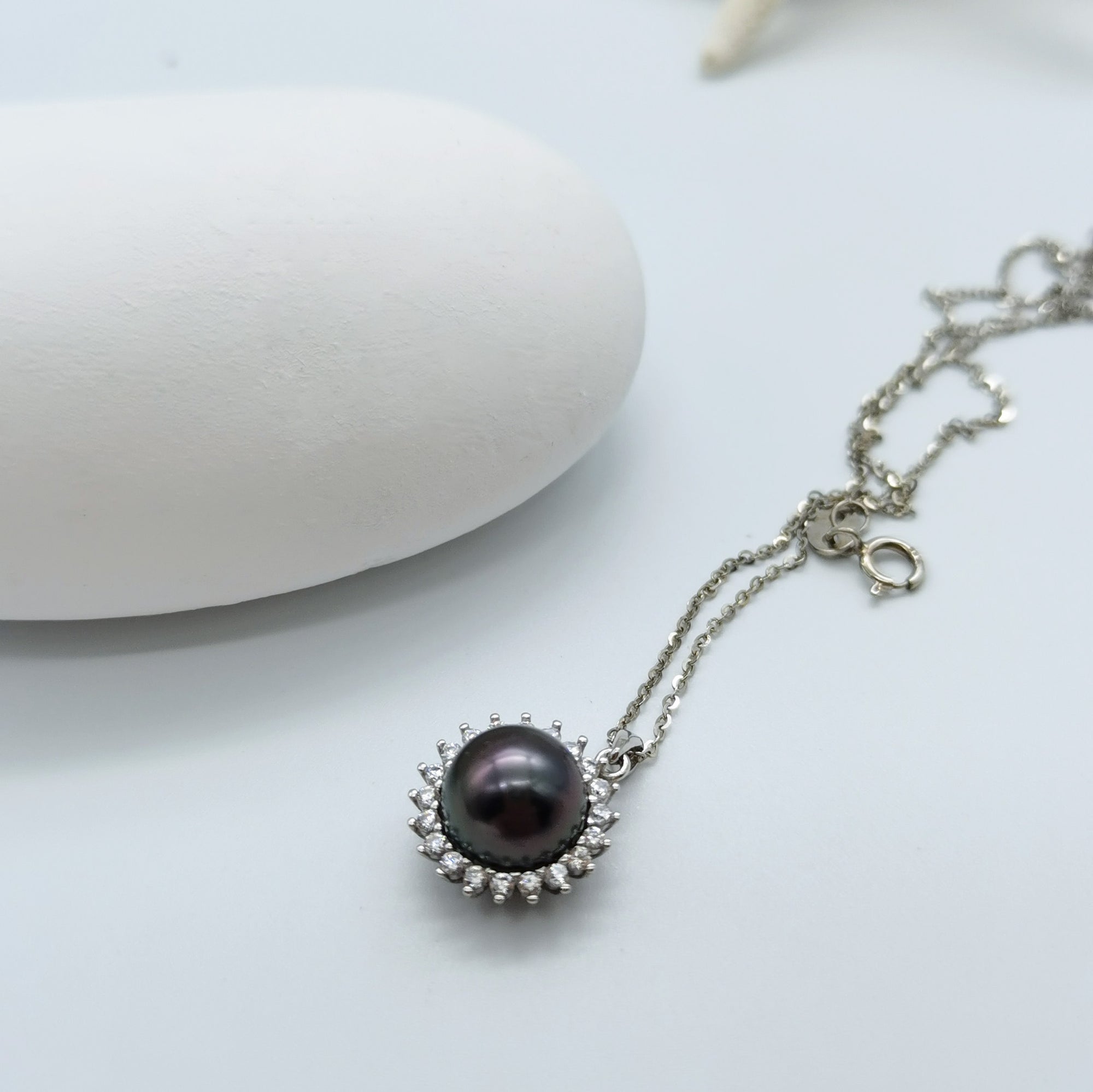 Tahitian pearl pendant necklace showing CZ halo setting 925 sterling silver chain sunburst mount openwork back design