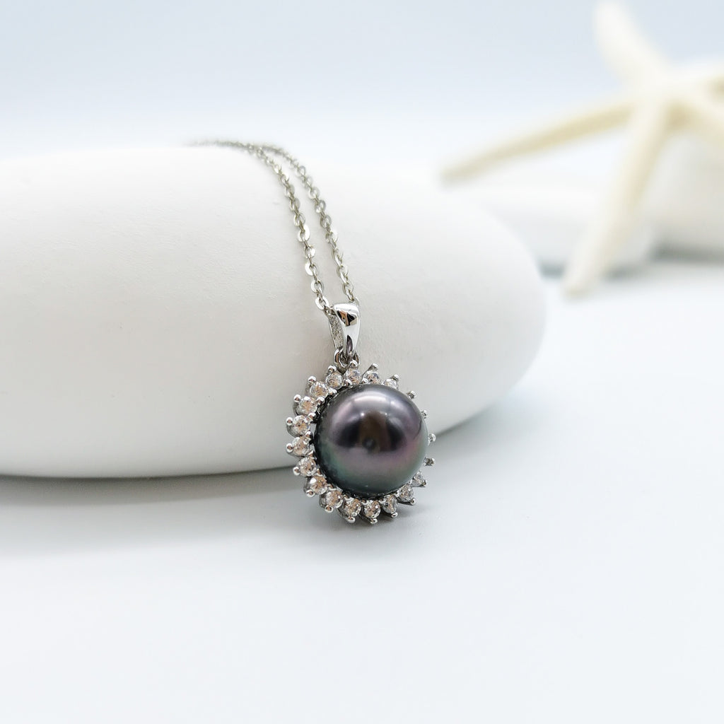 Tahitian pearl pendant necklace 10mm round pearl CZ halo 925 sterling silver sunburst mount showing peacock undertones