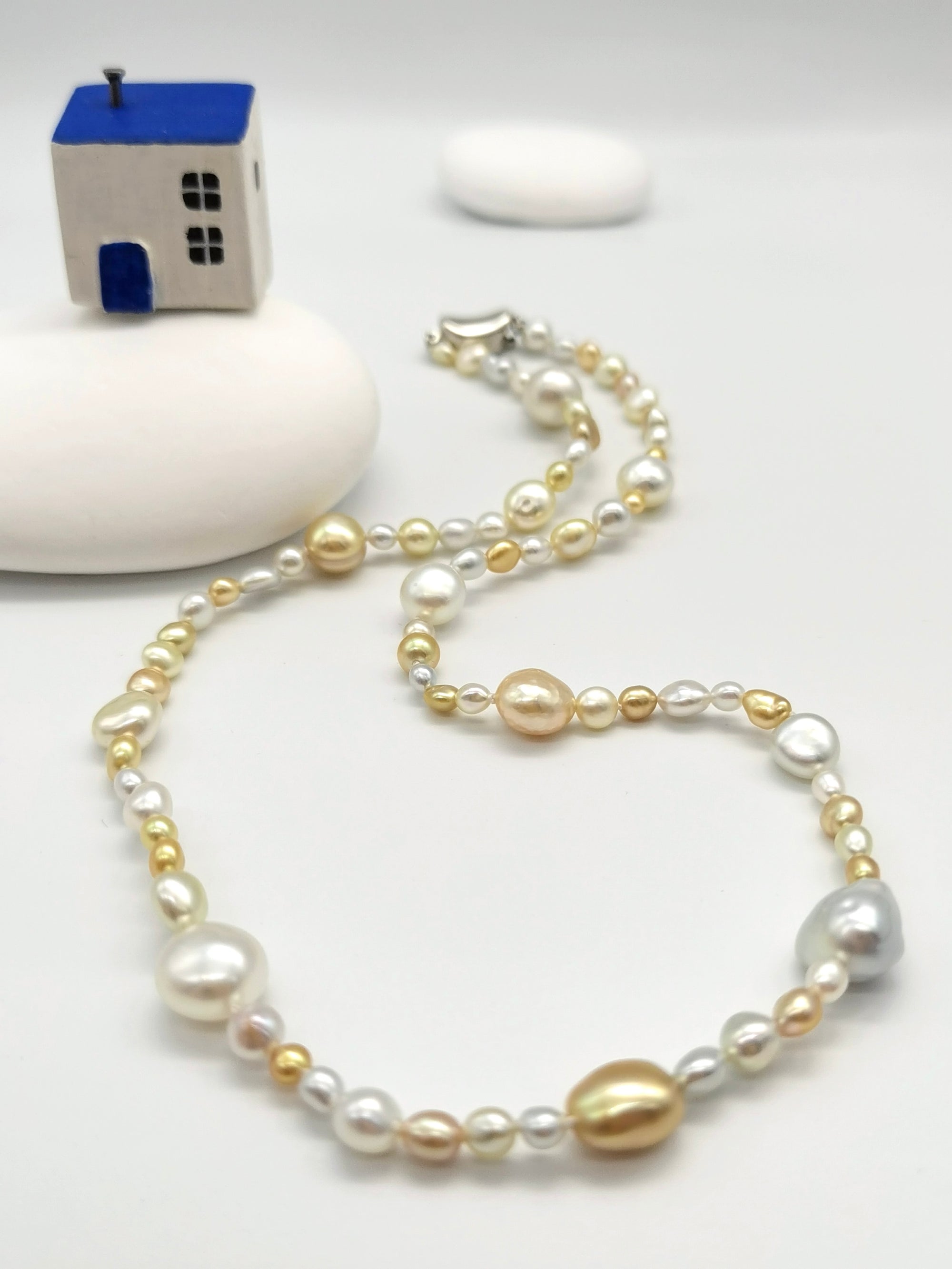 Close-up of South Sea gold and white keshi pearls in rivière pattern showing 3-10mm near-round flat shapes and exceptional lustre