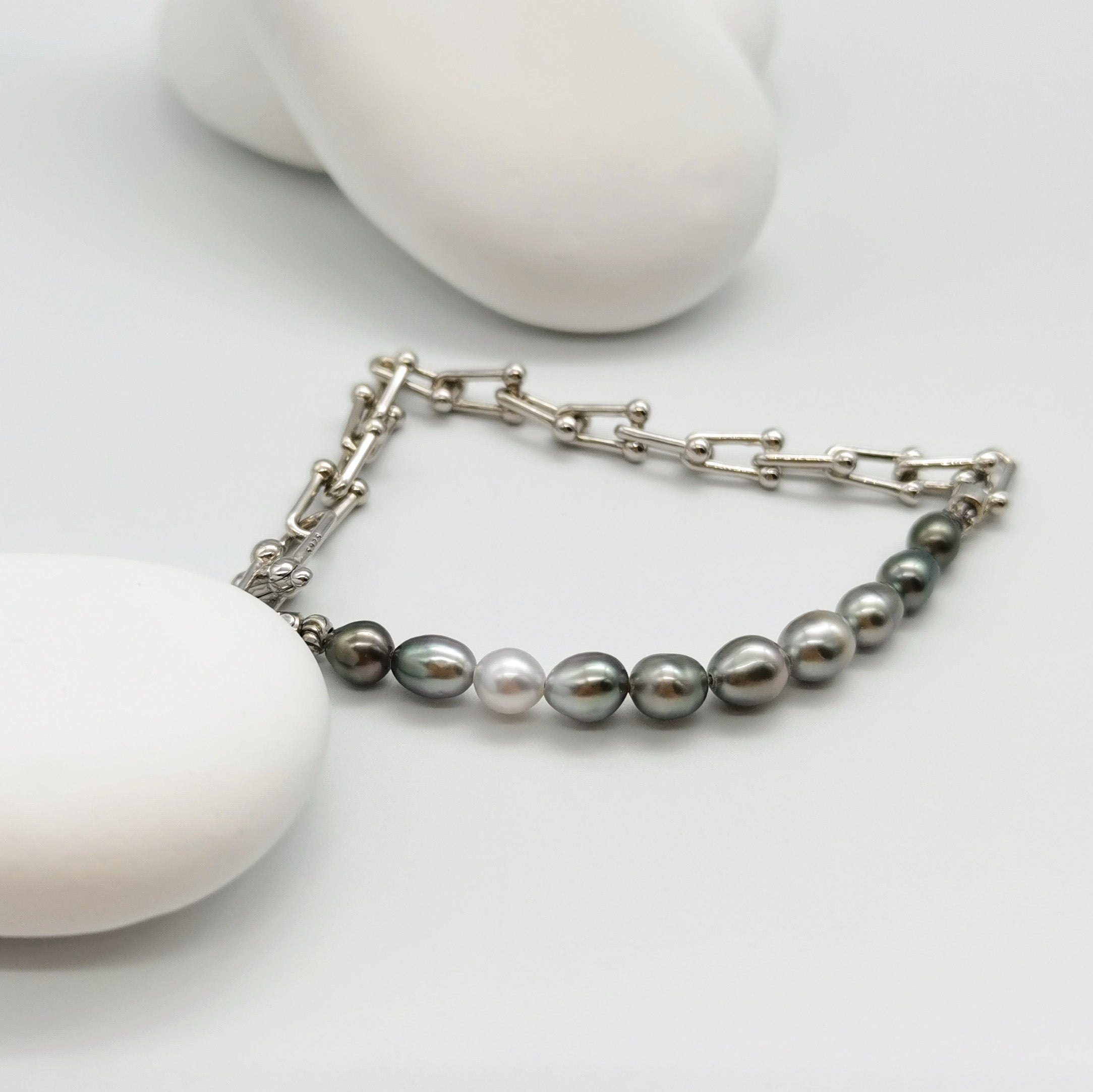Detailed view of Tahitian keshi pearl bracelet showing oval pearl shapes and sterling silver U-shaped gauge link construction