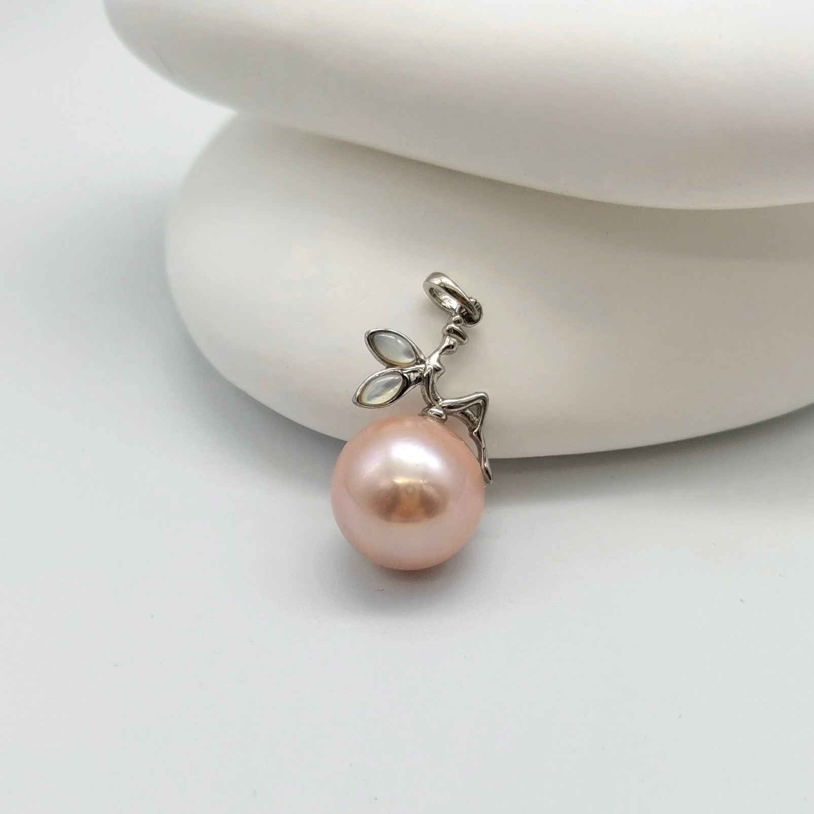 Pink freshwater pearl fairy pendant with sterling silver fairy sitting on 12mm round pearl, whimsical design