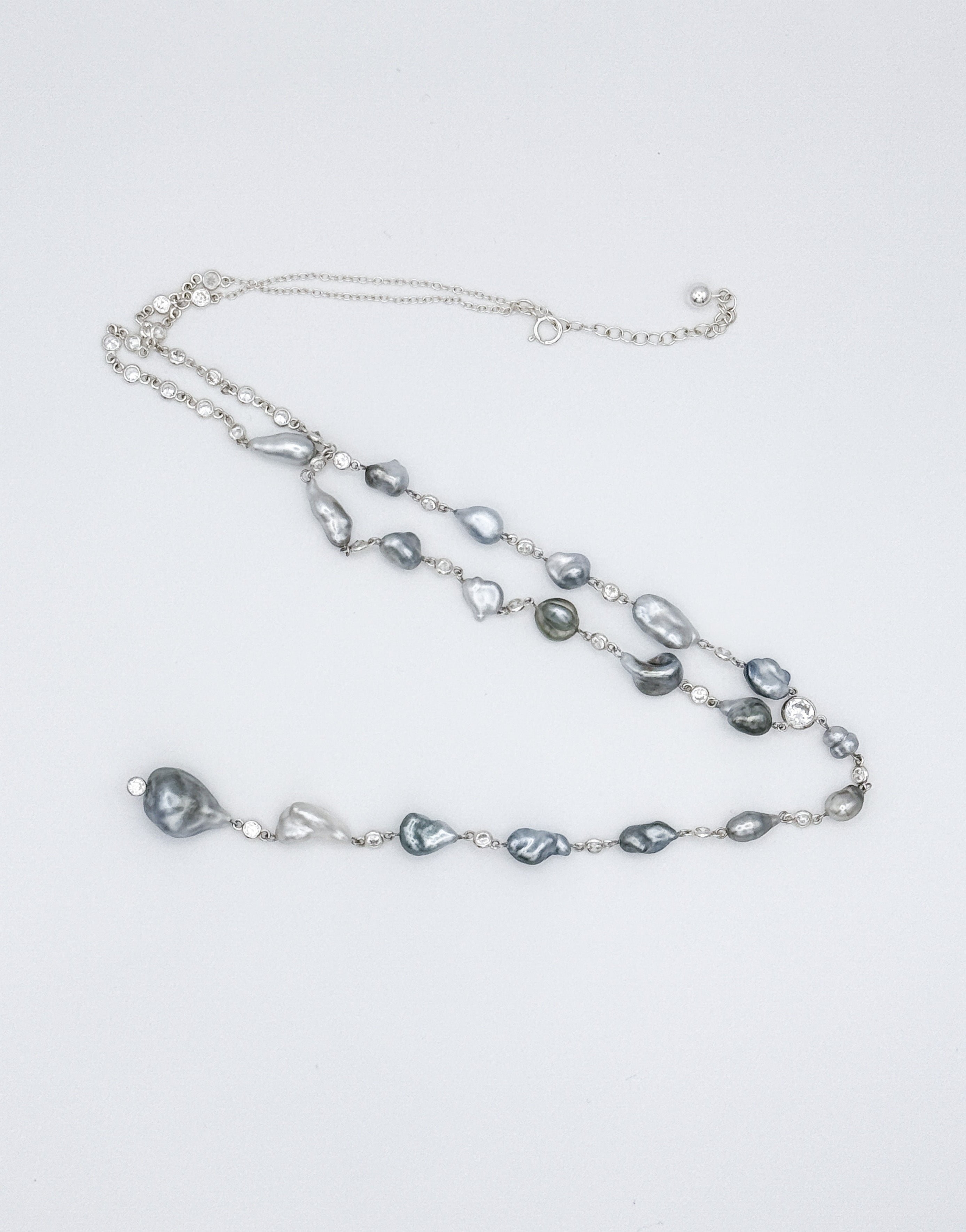 Flat lay of full necklace in Y formation showing pearl spacing and length