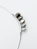 Close-up of Keshi pearls showing silver to bronze gradient and baroque shapes