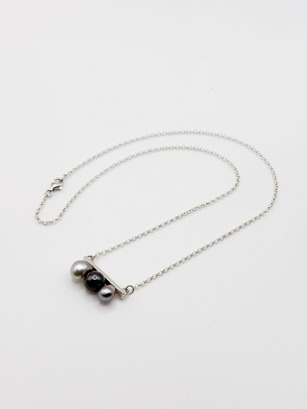Tahitian Keshi pearl necklace with three pearls on horizontal silver bar and fine chain
