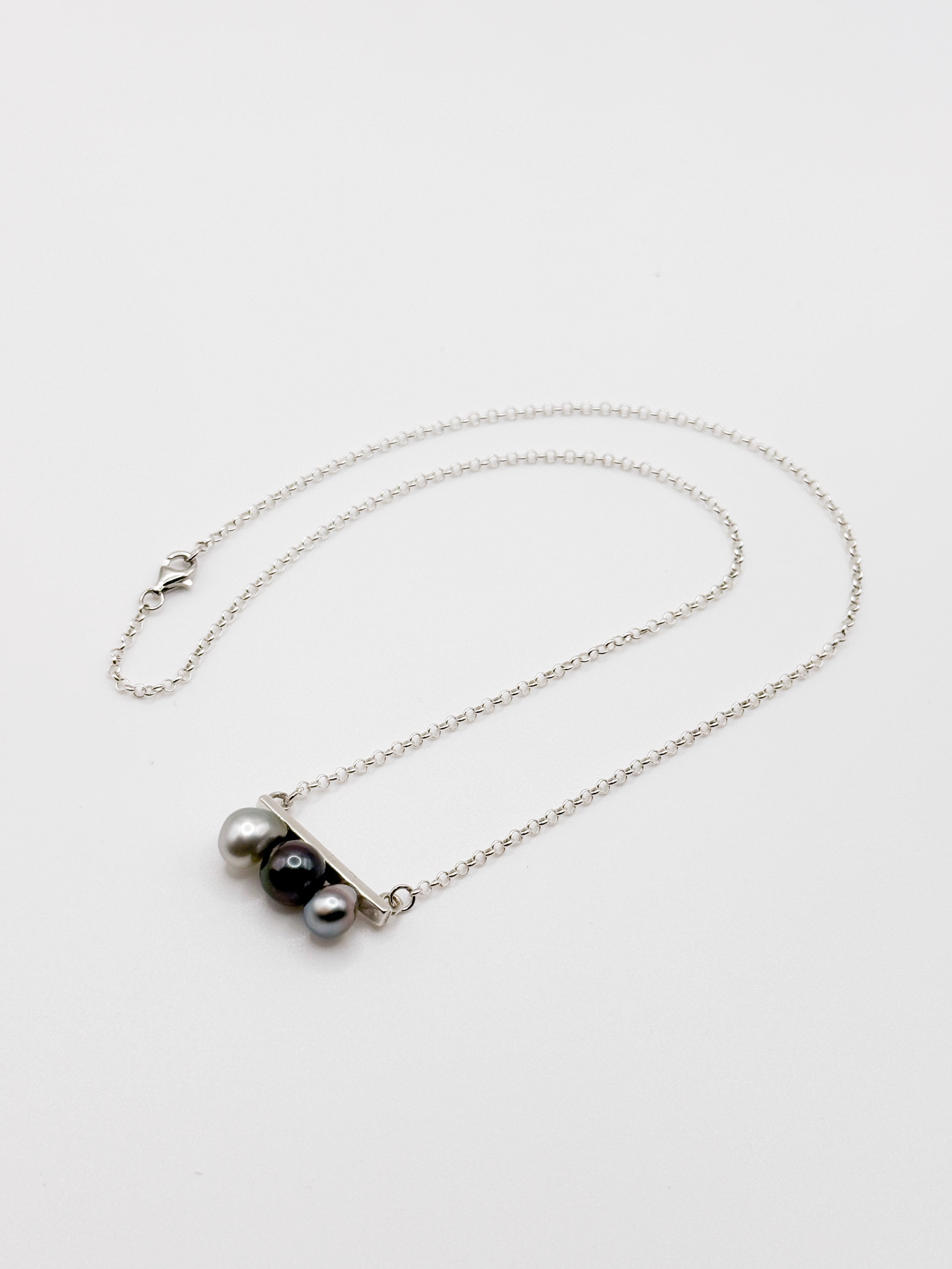 Tahitian Keshi pearl necklace with three pearls on horizontal silver bar and fine chain
