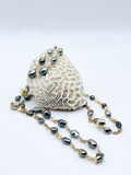 Close-up of necklace and earrings on coral prop 