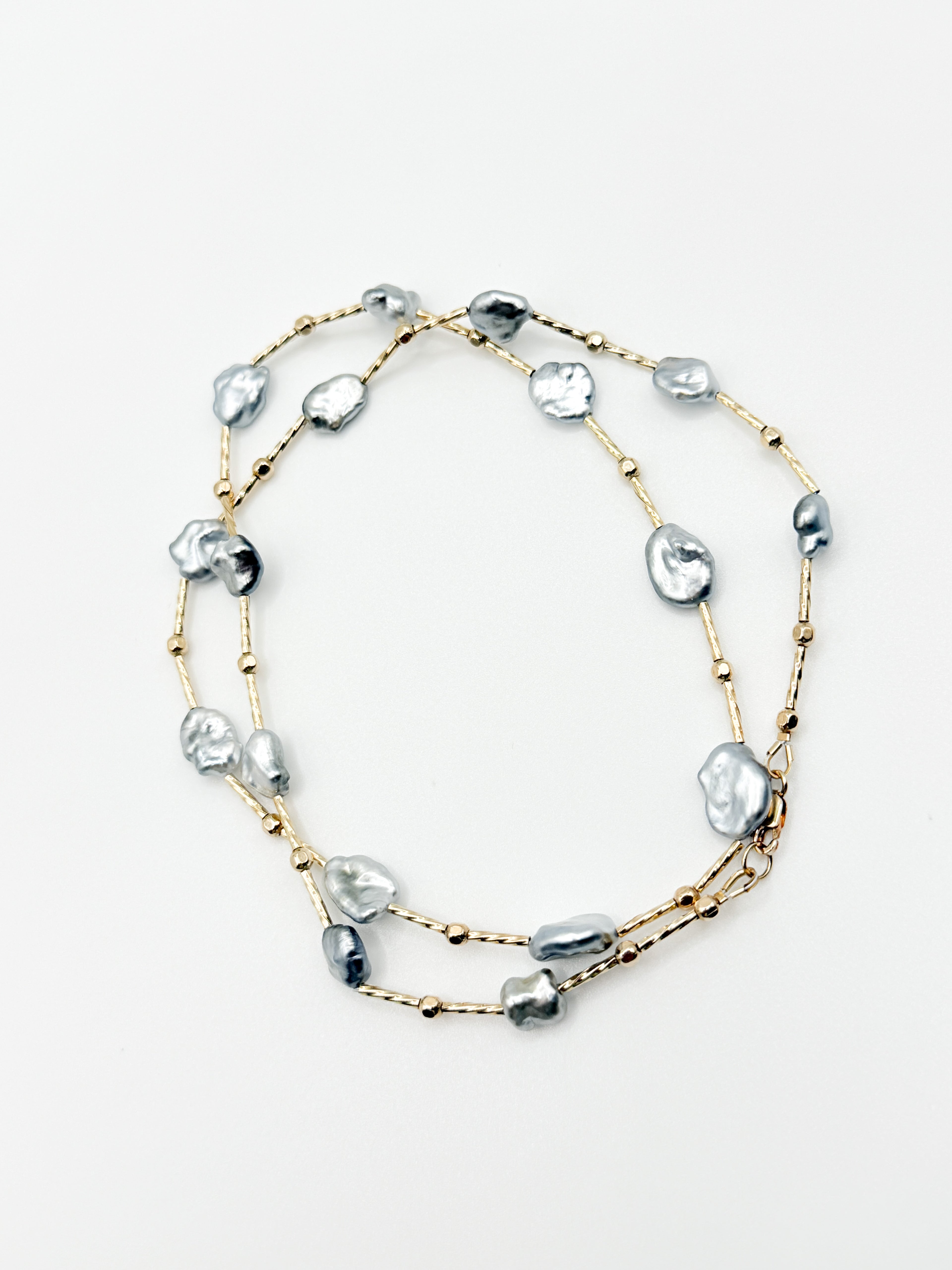 Top view of the necklace in a circle formation on plain white background