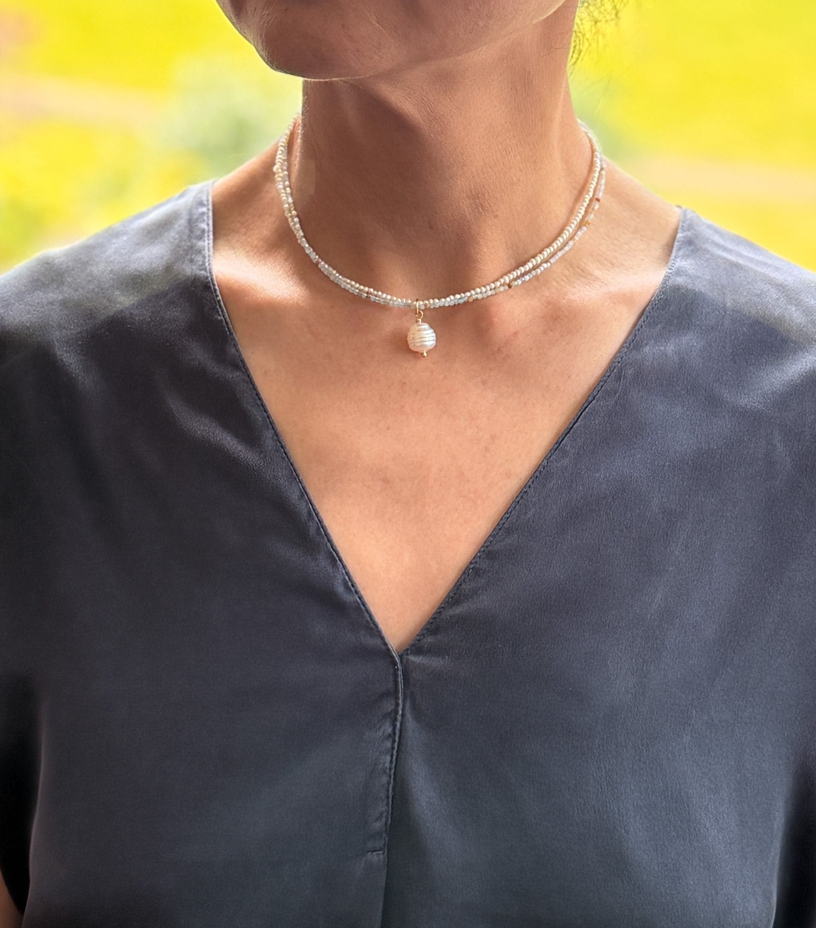 Model wearing South Sea pearl choker with seed pearls and amazonite beads, styled as a double-layer necklace.