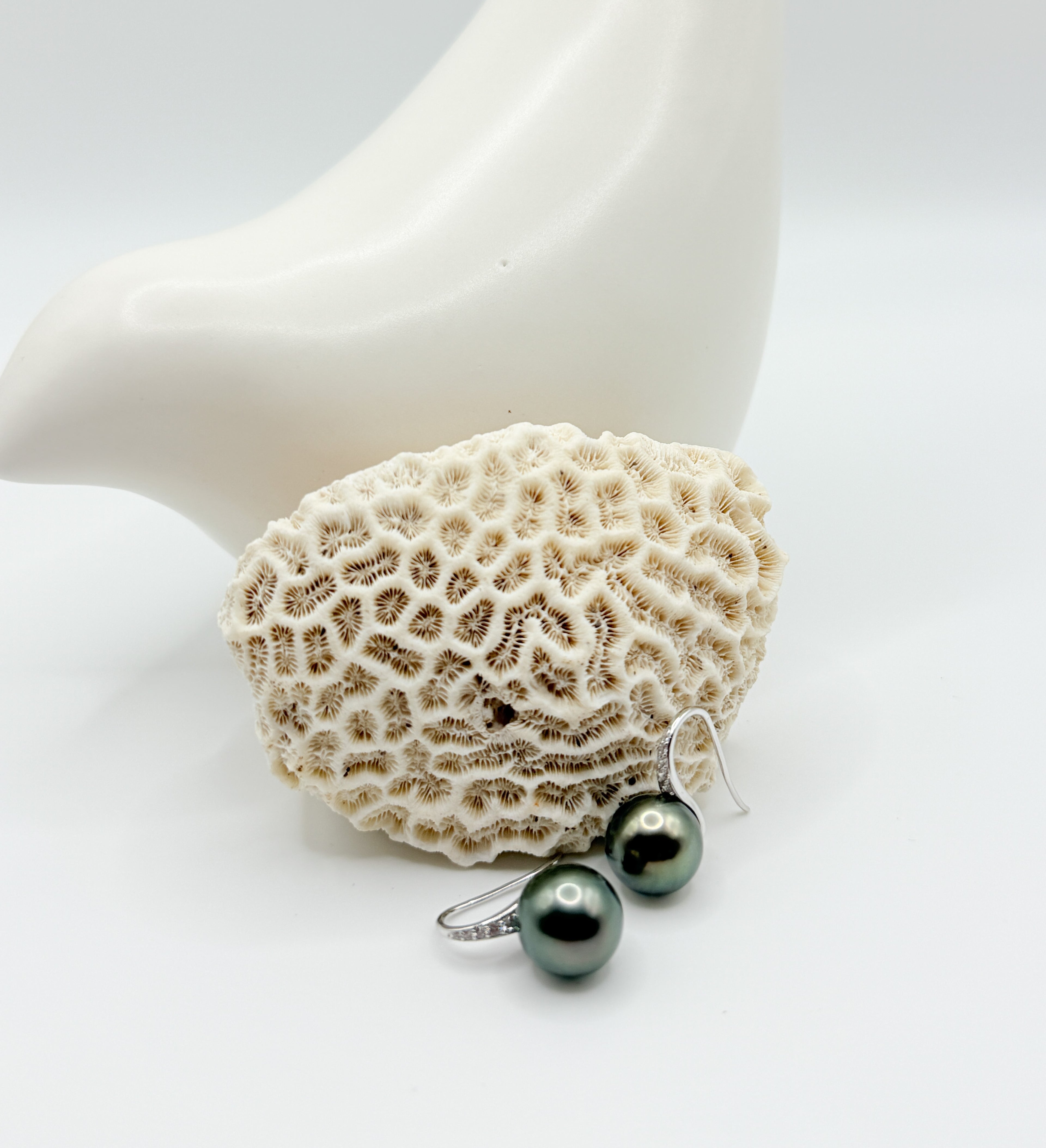 Classic Tahitian pearl drop earrings with sterling silver, arranged side by side for symmetry and sheen.