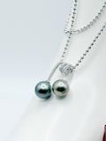 Close-up of double Tahitian baroque pearl pendant with CZ accents on a 925 sterling silver ball chain.