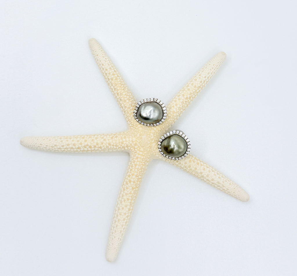 Top-down view of Tahitian Keshi pearl stud earrings on starfish showing CZ pavé halos silver charcoal olive pearl colours