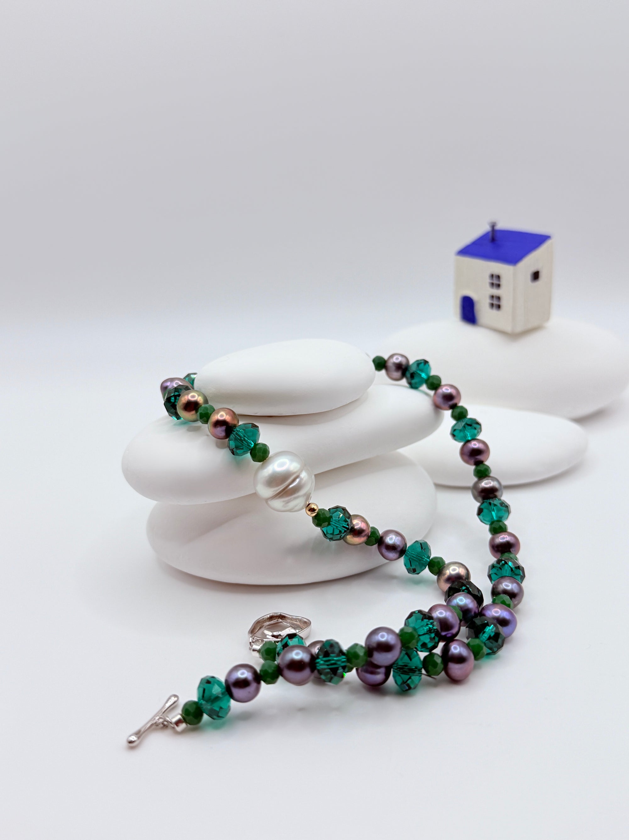 Full choker layout showing off-centre baroque pearl placement with purple freshwater pearls and sterling silver OT toggle clasp detail