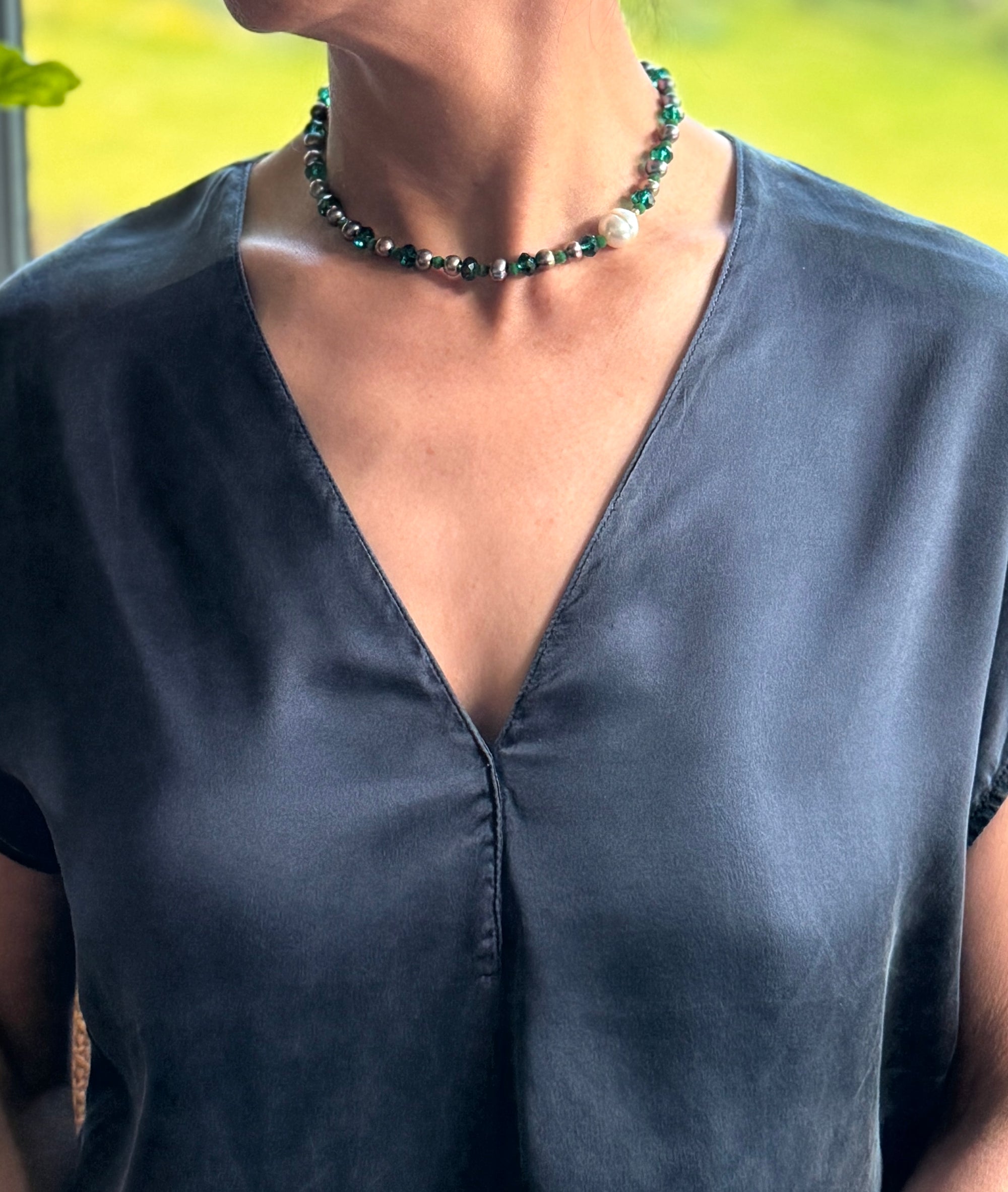 Model wearing choker showing styling of the off-centre design, elegant and playful with colour combinations