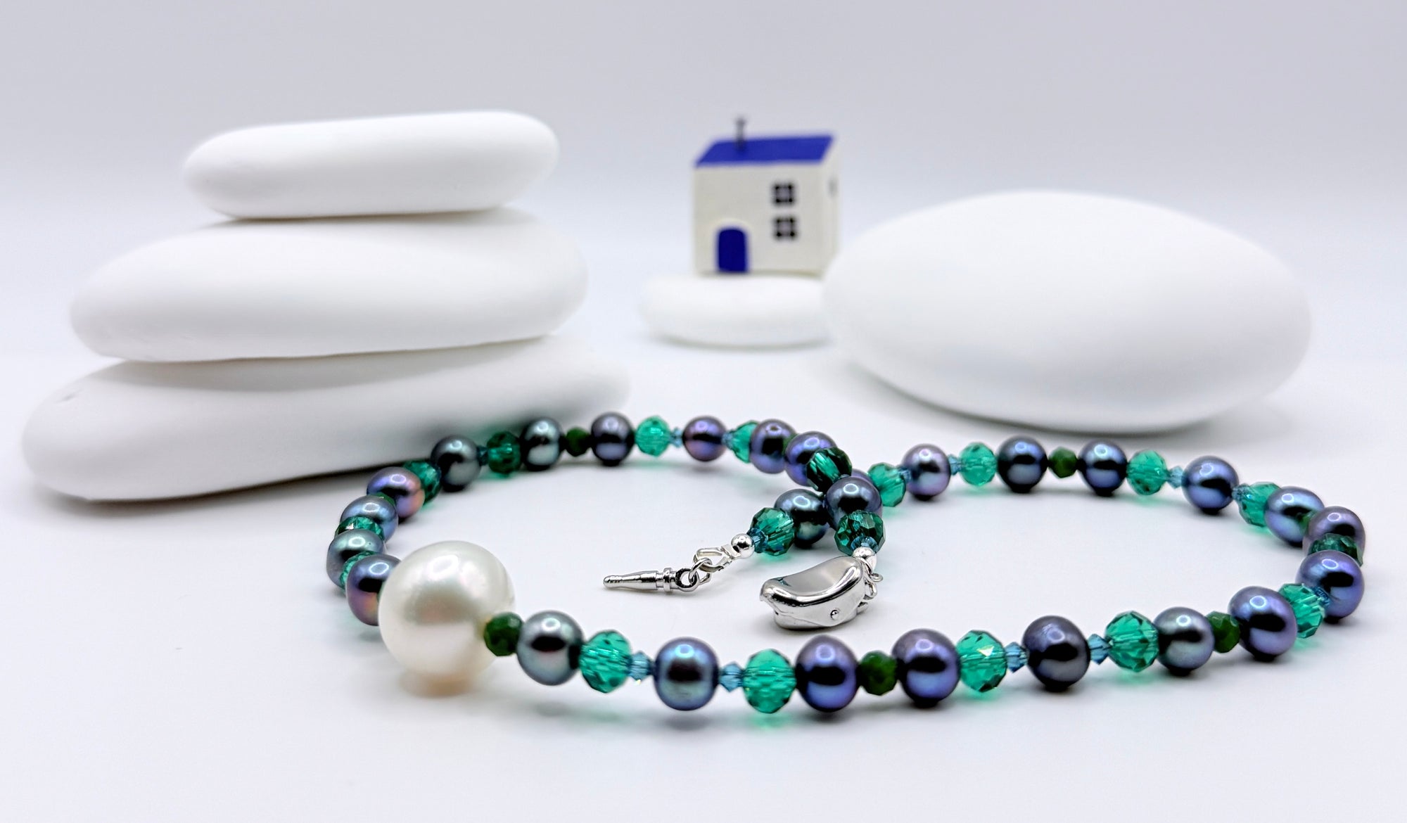 Full necklace layout showing blue freshwater pearls with green crystal glass beads and sterling silver push-in clasp detail