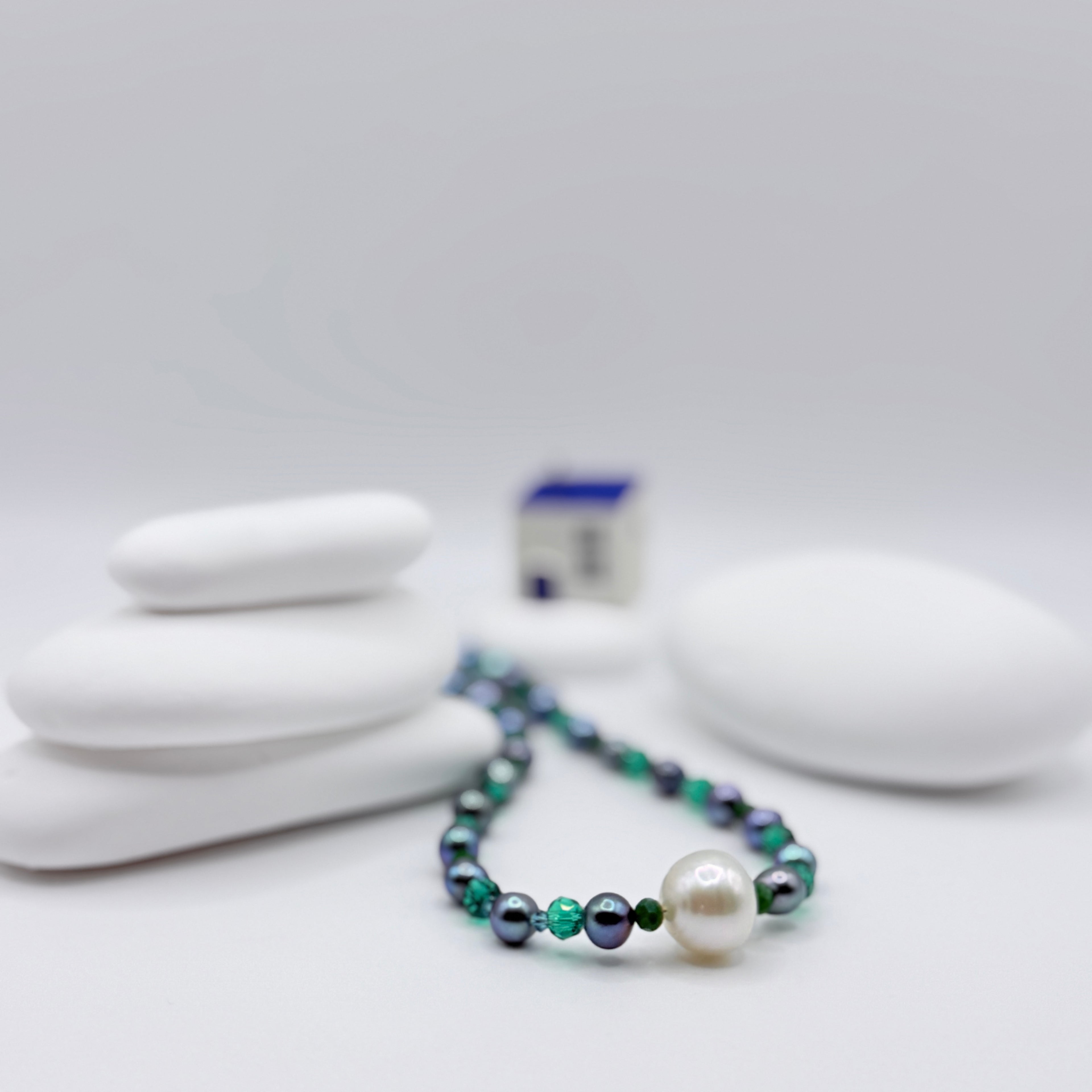 White South Sea pearl necklace with blue freshwater pearls and green crystal beads, 40cm length with off-centre baroque pearl arrangement