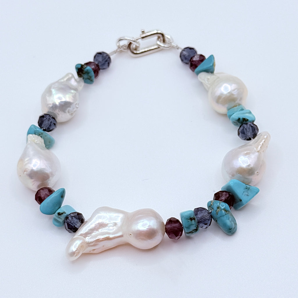 Pearl bracelet set styled together displaying colour harmony of white pearls with blue purple crystals and turquoise accents