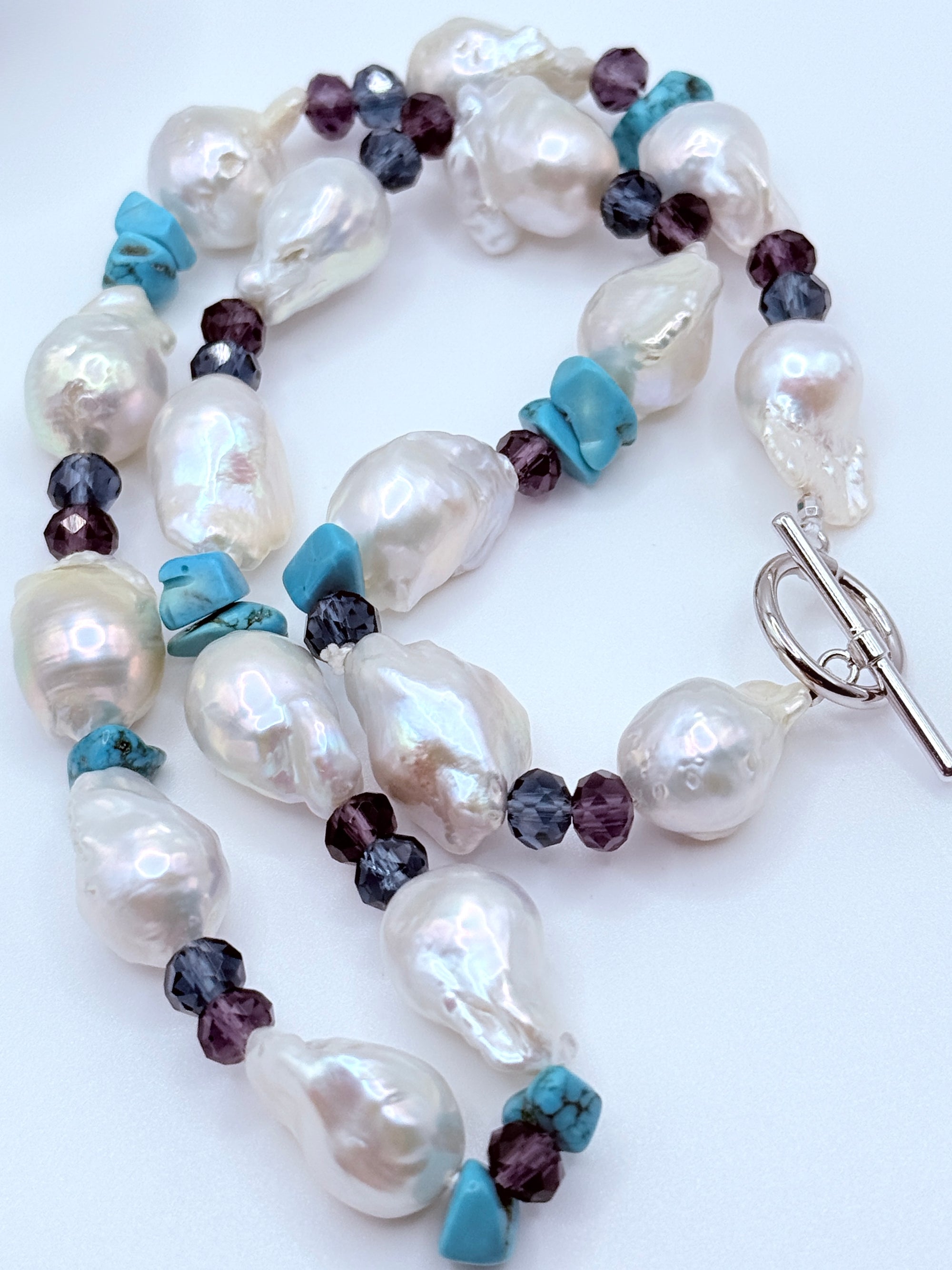 Full necklace layout showing 17 baroque pearls with natural blemishes and sterling silver toggle clasp detail