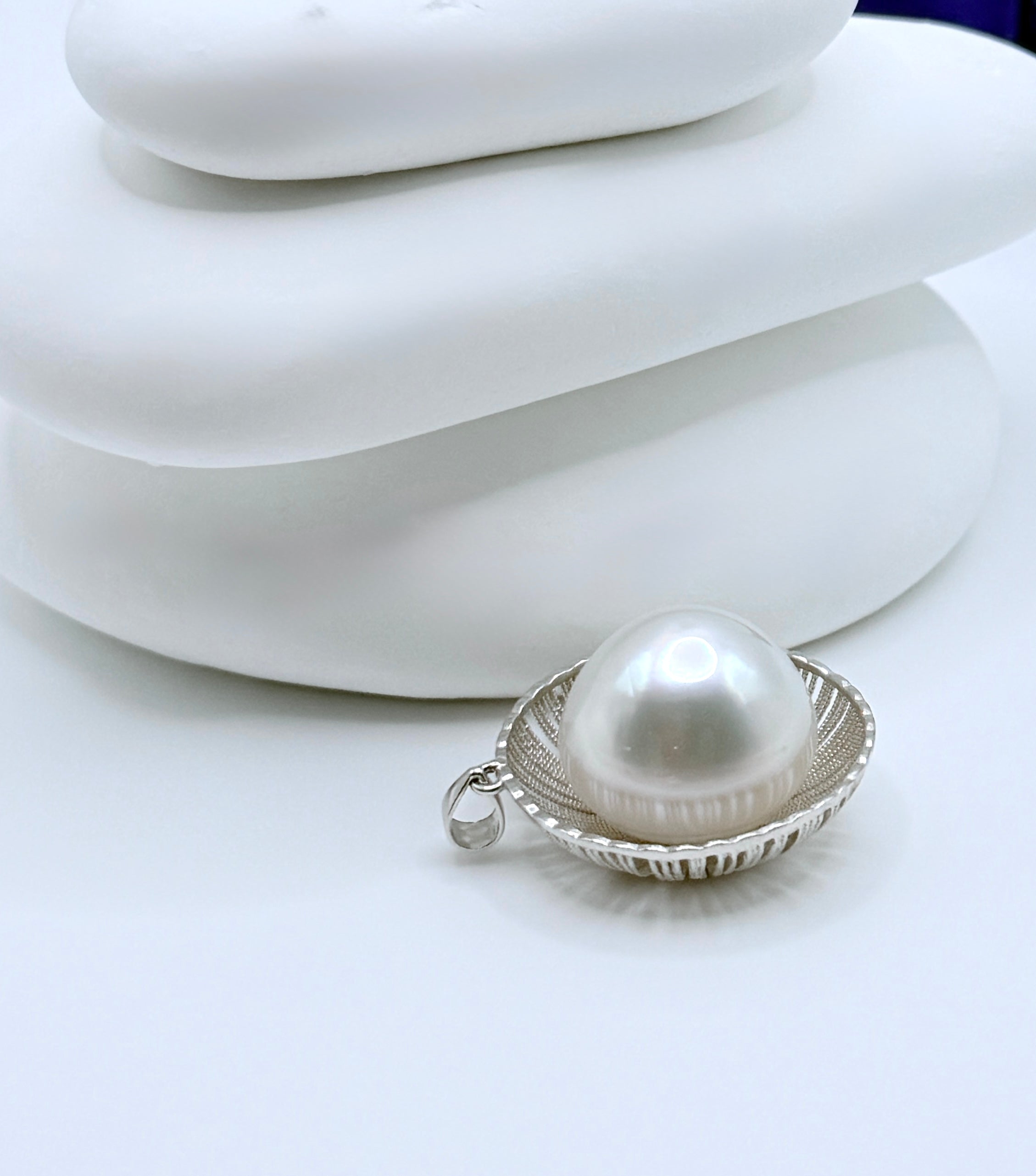 Close-up view of white South Sea baroque pearl showing natural lustre and organic shape in decorative sterling silver setting
