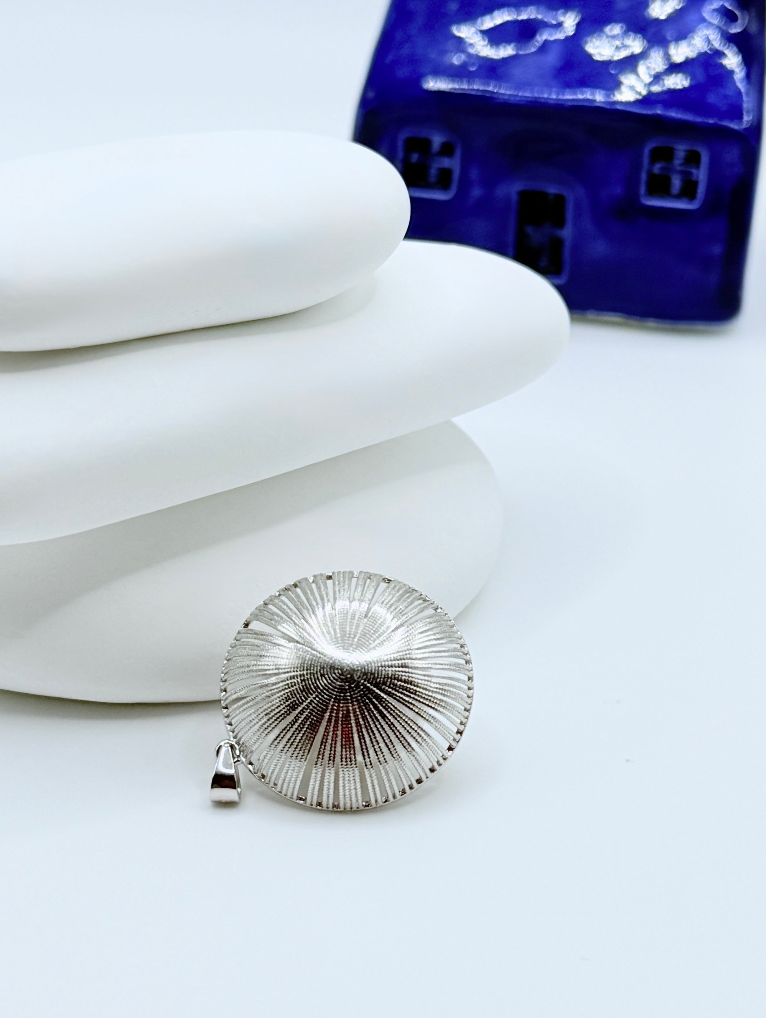 Back view of sterling silver pendant showing detailed ridged metalwork and bail construction