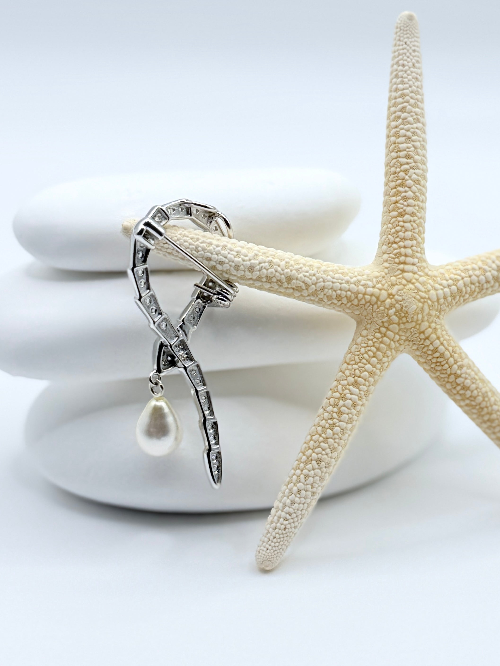 Back view of snake brooch showing sterling silver construction and secure pin fastening mechanism with starfish