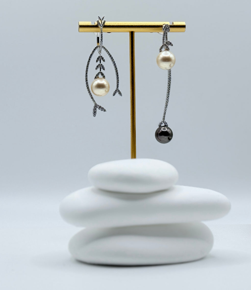 Detailed side view of sterling silver earrings with contrasting botanical and minimalist designs featuring South Sea and Tahitian pearls