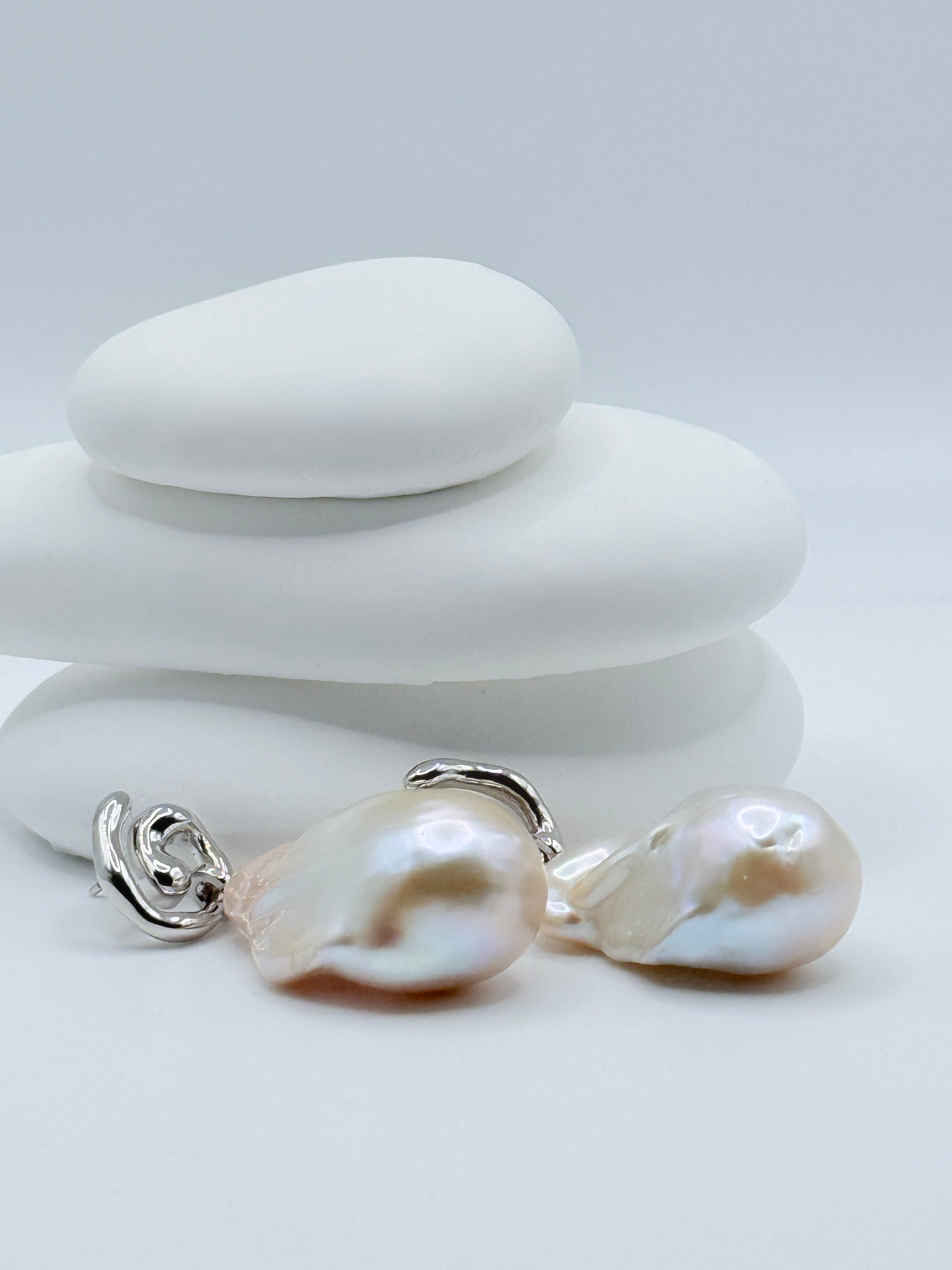 Sterling silver convertible earrings with 20x30mm baroque freshwater pearls displaying iridescent lustre and elegant curved details on white stones