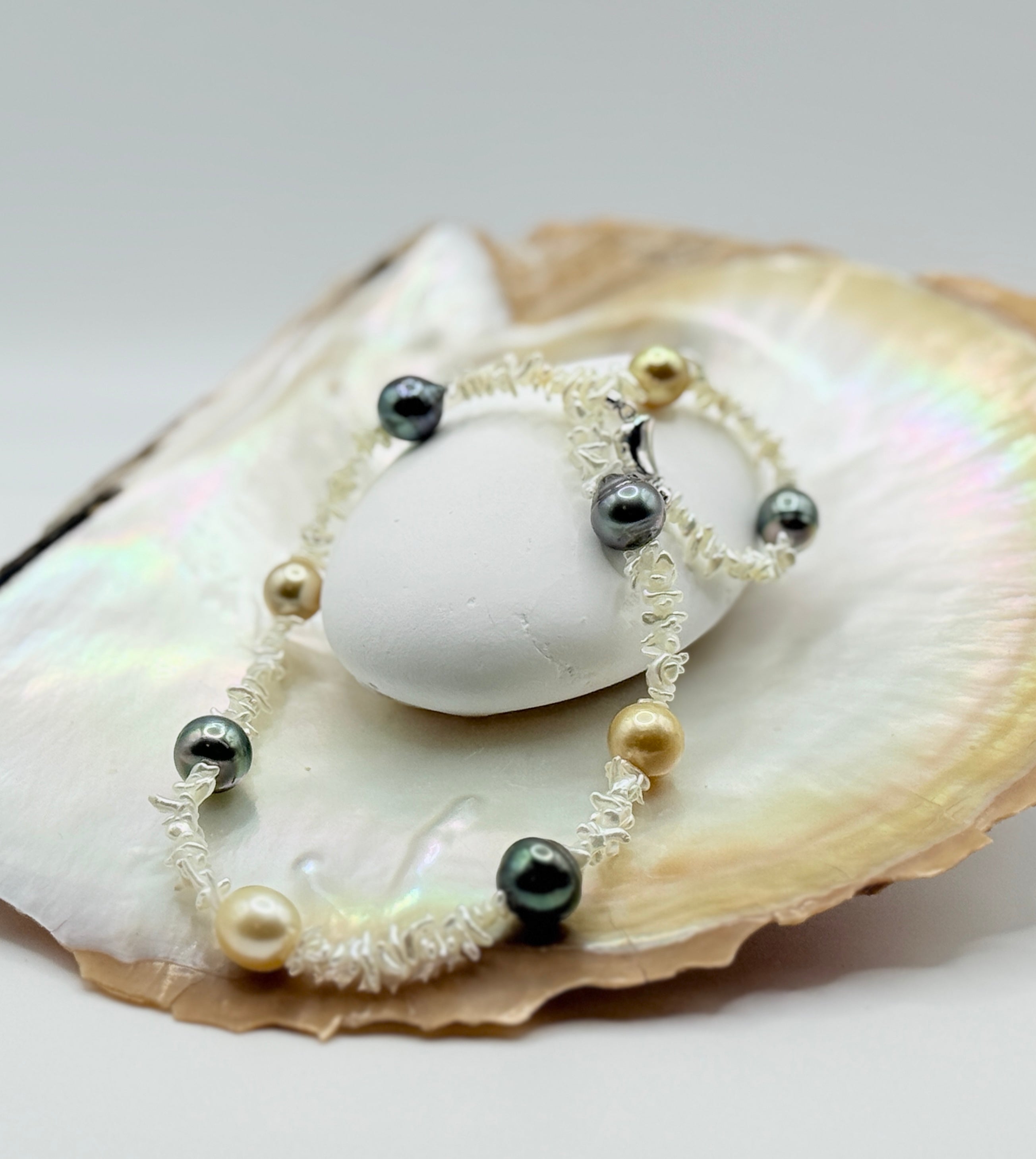 Pearl necklace with Southsea gold and Tahitian pearl on strand of akoya keshi on a golden oyster shell