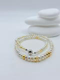 Detailed view of graduated South Sea keshi roundel strand showing elegant rivière style with ball and bar clasp on white stones