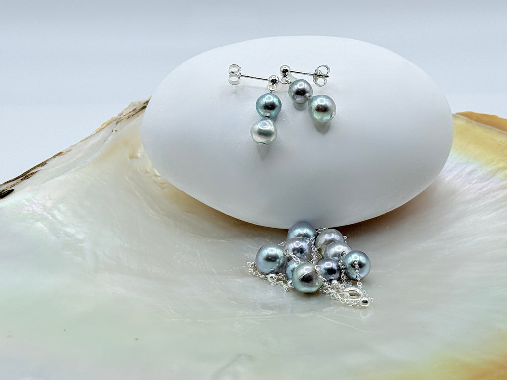 Close-up of blue baroque Akoya pearls on sterling silver station necklace showing natural lustre on mother of pearl shell