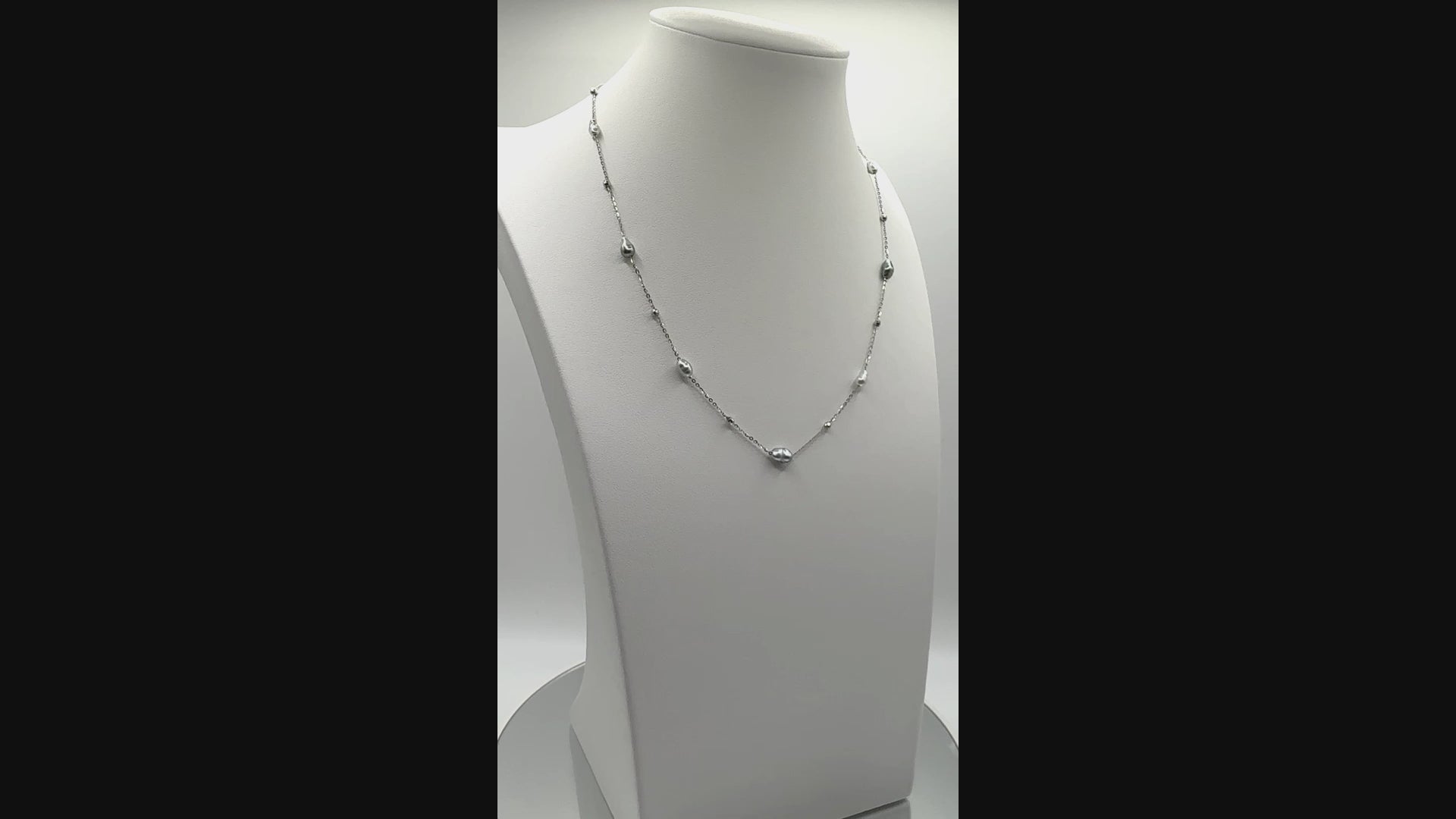 Rotating video of Tahitian Keshi station necklace showing soft shimmer and delicate spacing of pearls along sterling silver chain