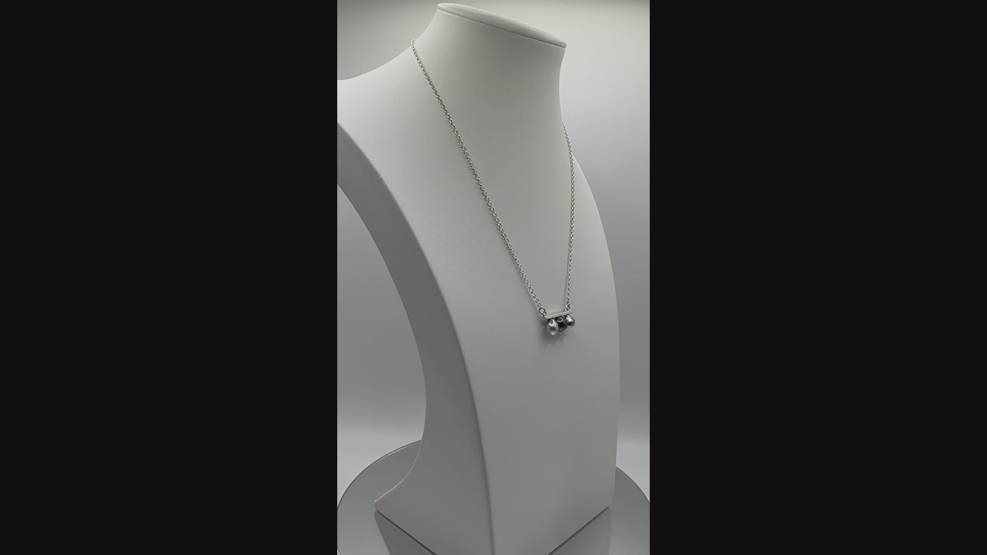 Rotating video of three-pearl bar necklace showing lustre and movement of Keshi pearls from different angles on display bust