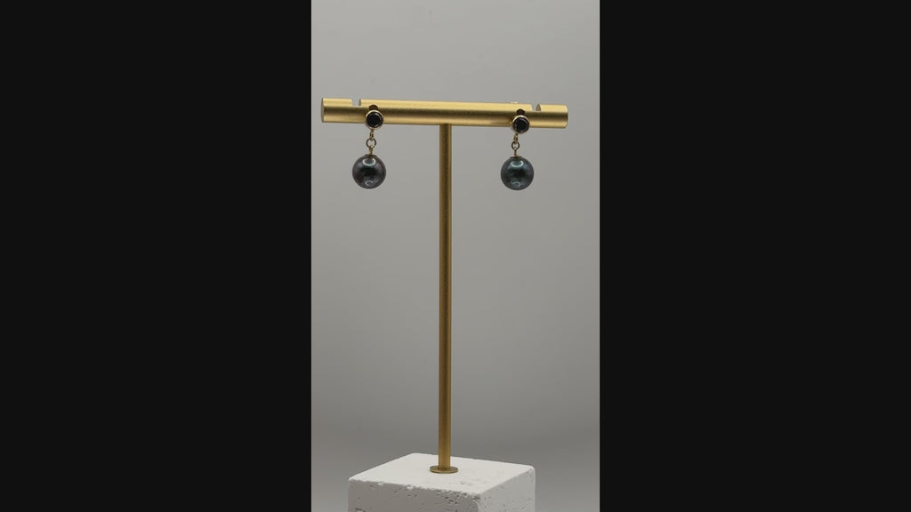 Rotating view of Tahitian pearl earrings showing movement, pearl sheen, and sparkle of black CZ studs on gold-plated settings