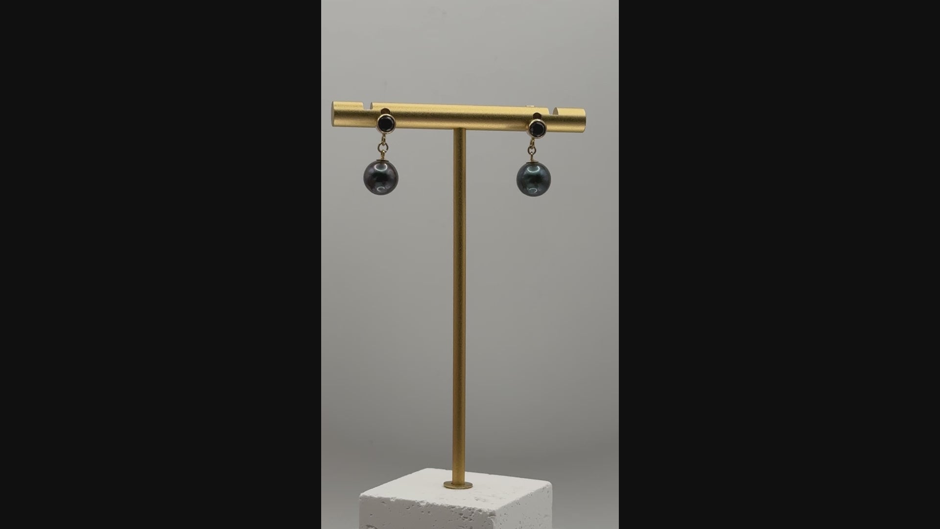 Rotating view of Tahitian pearl earrings showing movement, pearl sheen, and sparkle of black CZ studs on gold-plated settings