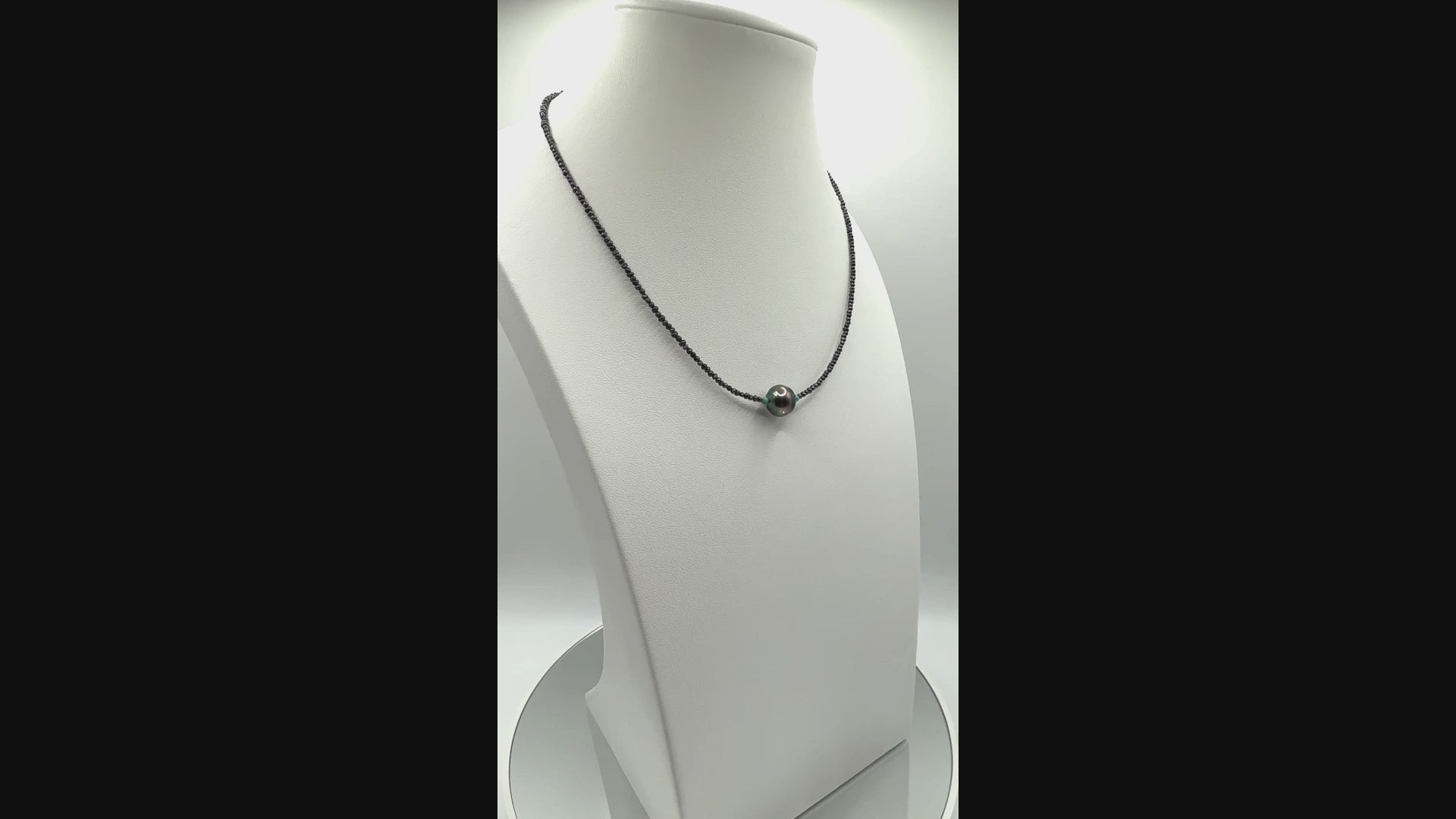 Video showing delicate choker with Tahitian baroque pearl and seed pearls rotating to display all angles of the central pearl and fine bead construction