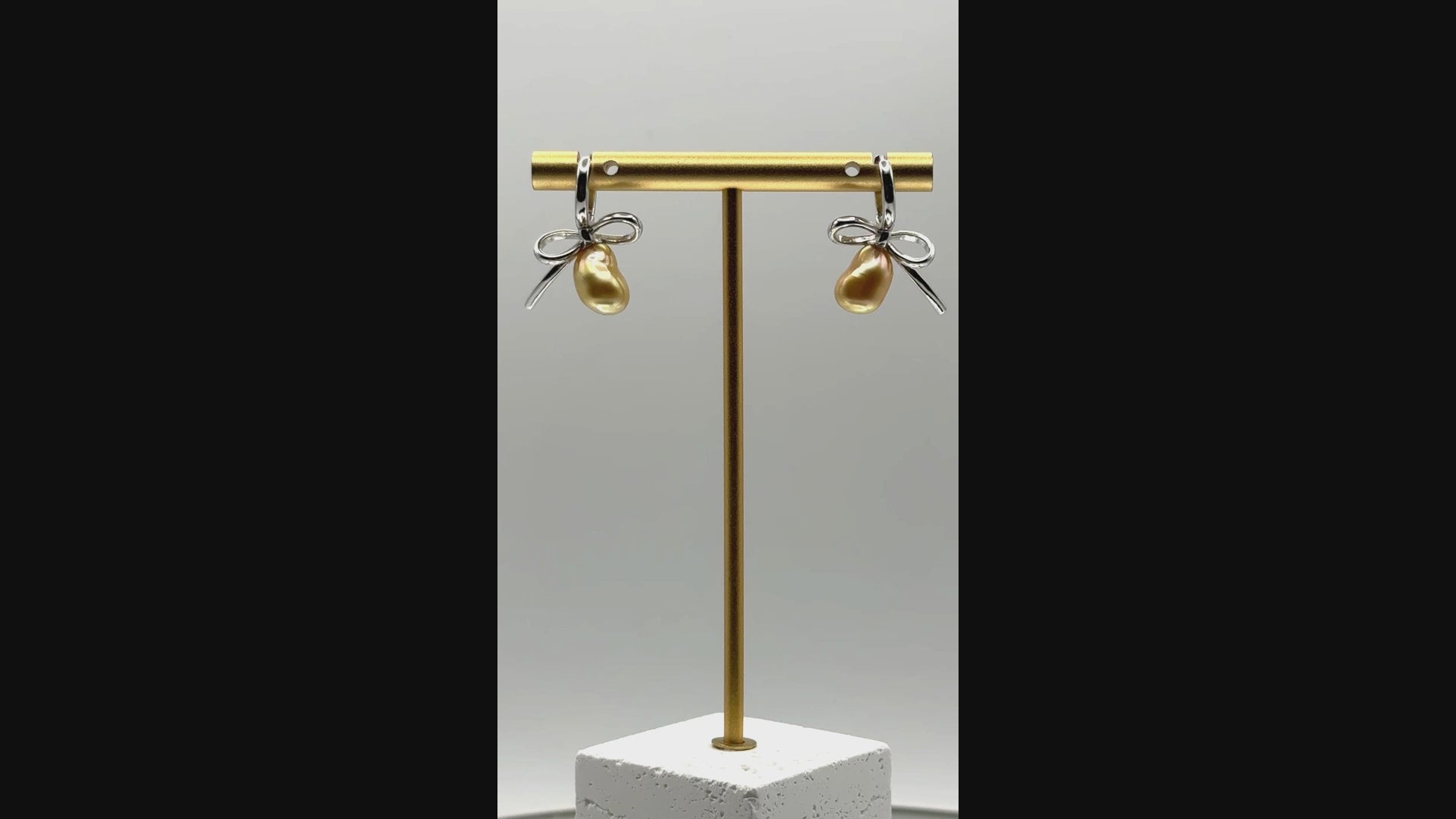 Video of golden South Sea Keshi pearl earrings with sterling silver bow hoops, showing movement and pearl lustre.