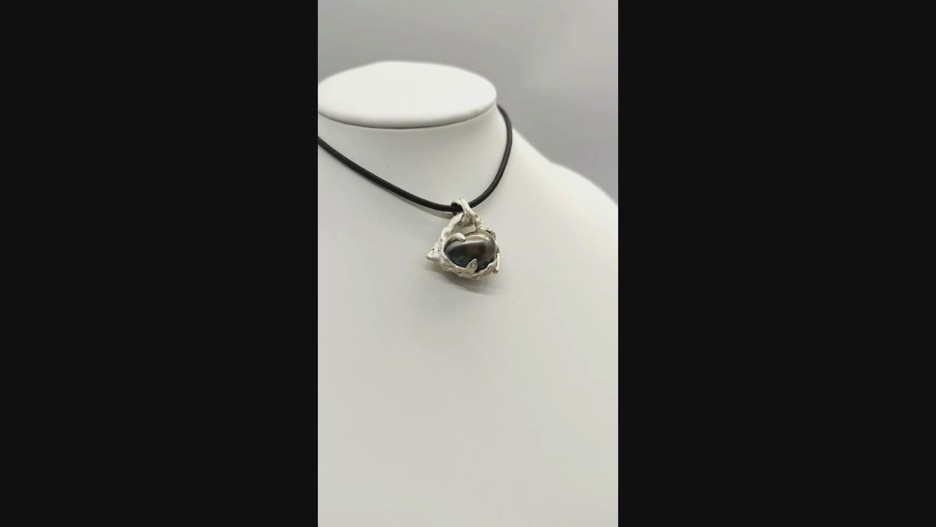 Video of Tahitian pearl heart pendant on a white bust rotating showing the style of the item being worn.
