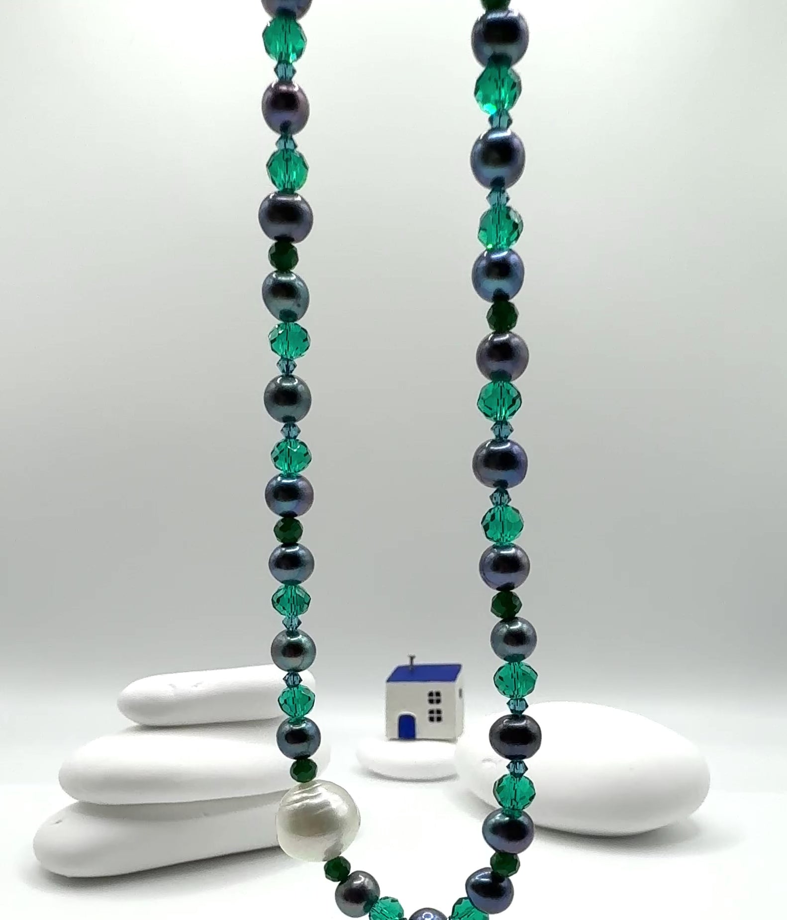 Video showing necklace movement displaying lustre of white South Sea pearl with blue freshwater pearls and crystal accents