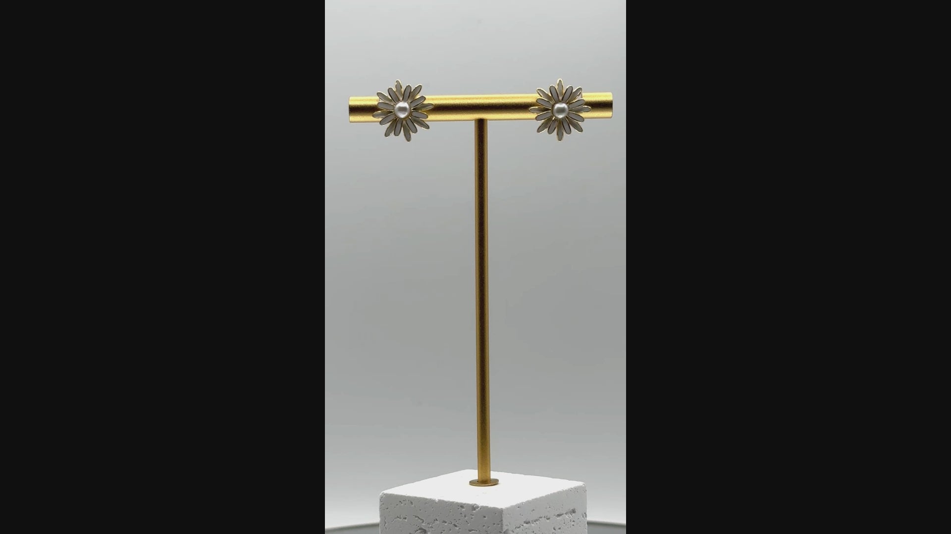 Rotating video of enamel daisy earrings showing central South Sea Keshi pearls and shimmer of silver posts from multiple angles