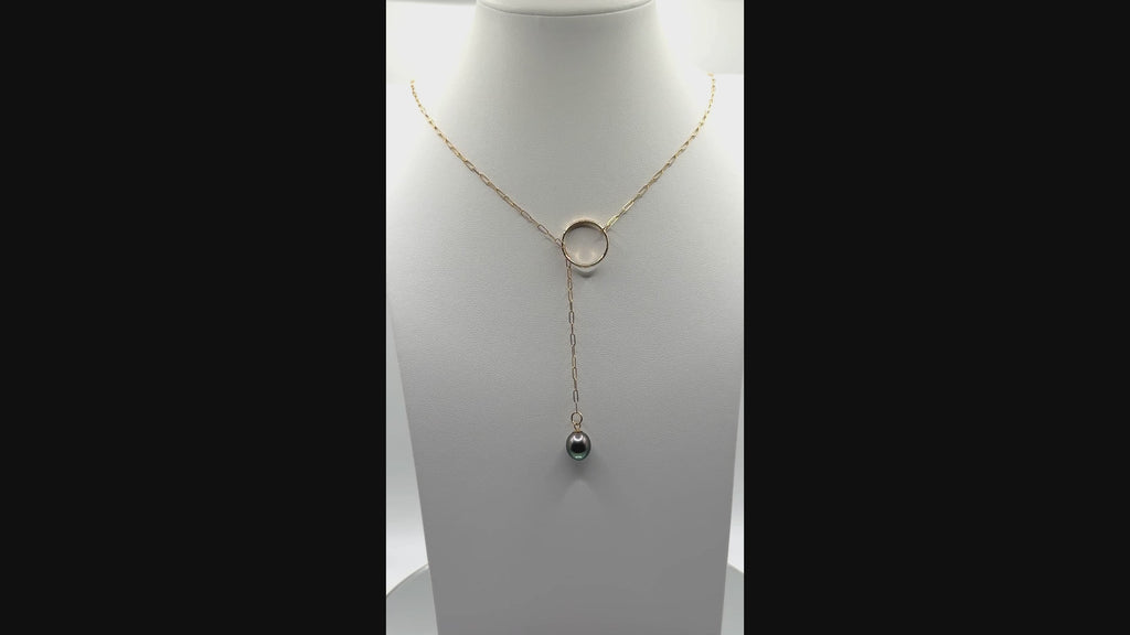 Video showing gold chain lariat necklace with Tahitian pearl rotating to display all angles of the baroque pearl and chain construction